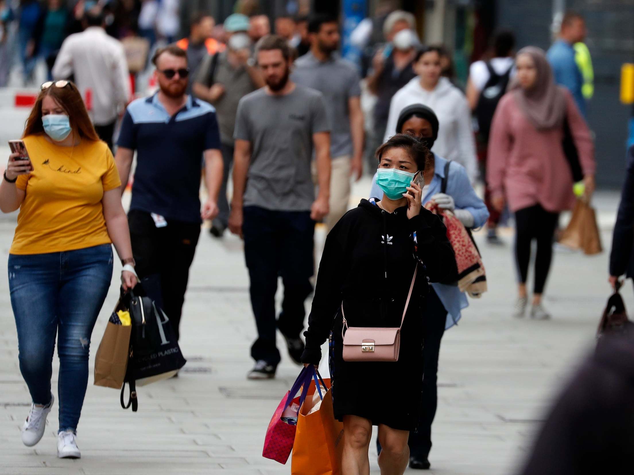 Customers wear masks as they shop at Primark in Oxford Street