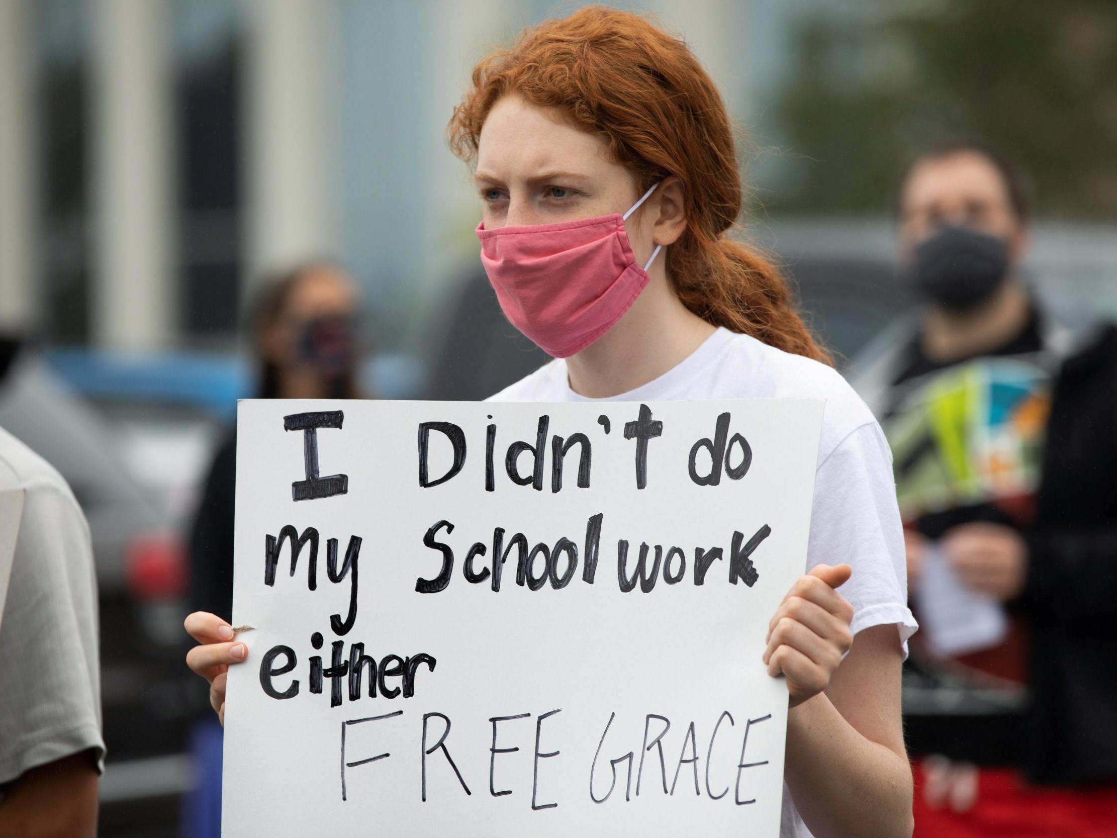 Students protest in support of a Black Groves High School student, who was jailed due to a probation violation of not keeping up with her online schoolwork