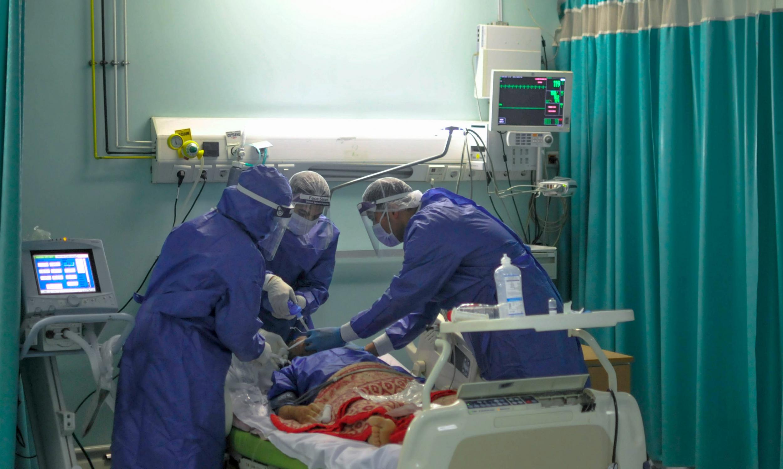 A picture taken by a doctor in Cairo shows medical staff with a patient in a coronavirus isolation ward