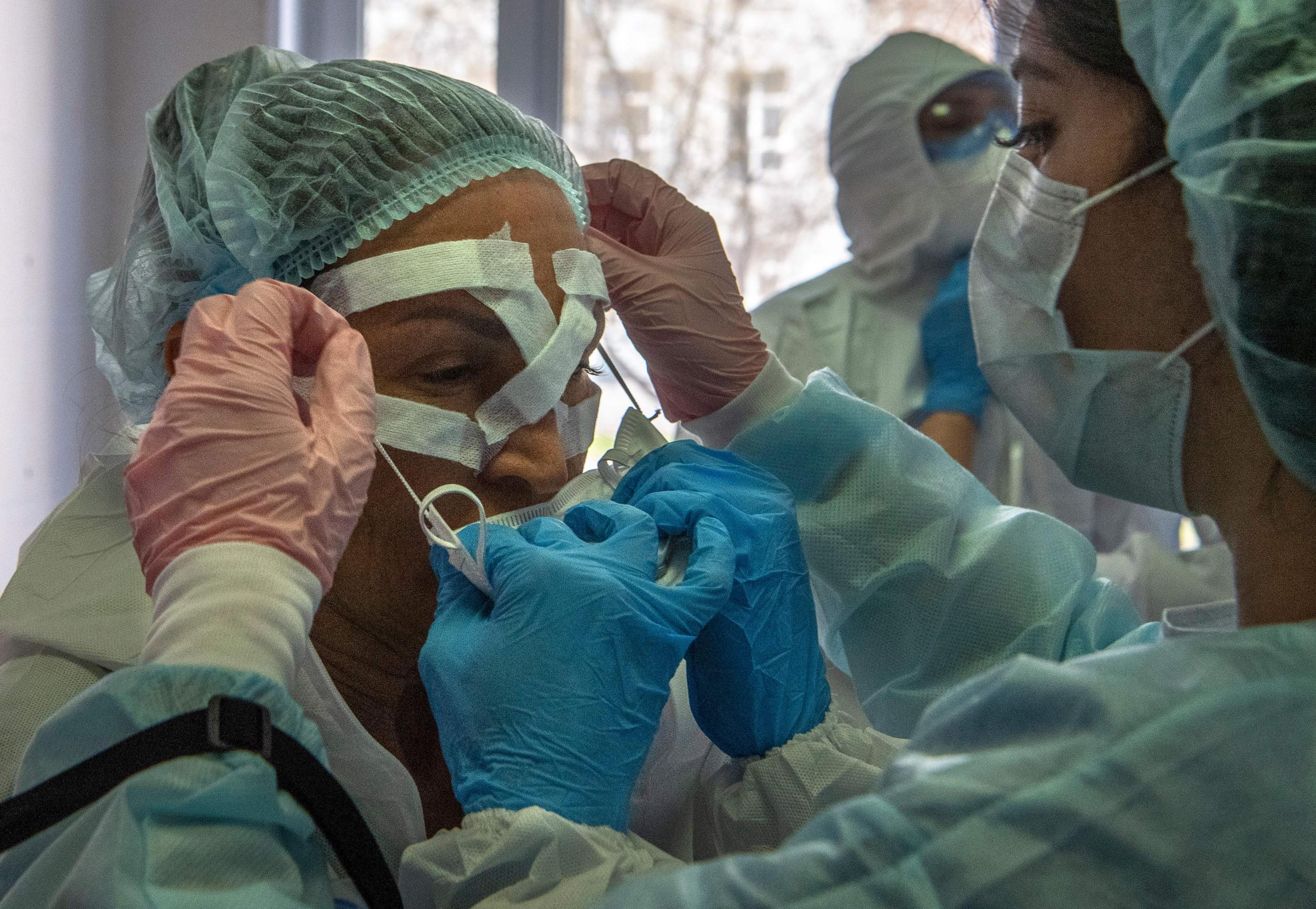 Medical workers get ready for a shift treating coronavirus patients at the Spasokukotsky clinical hospital in Moscow (AFP via Getty)