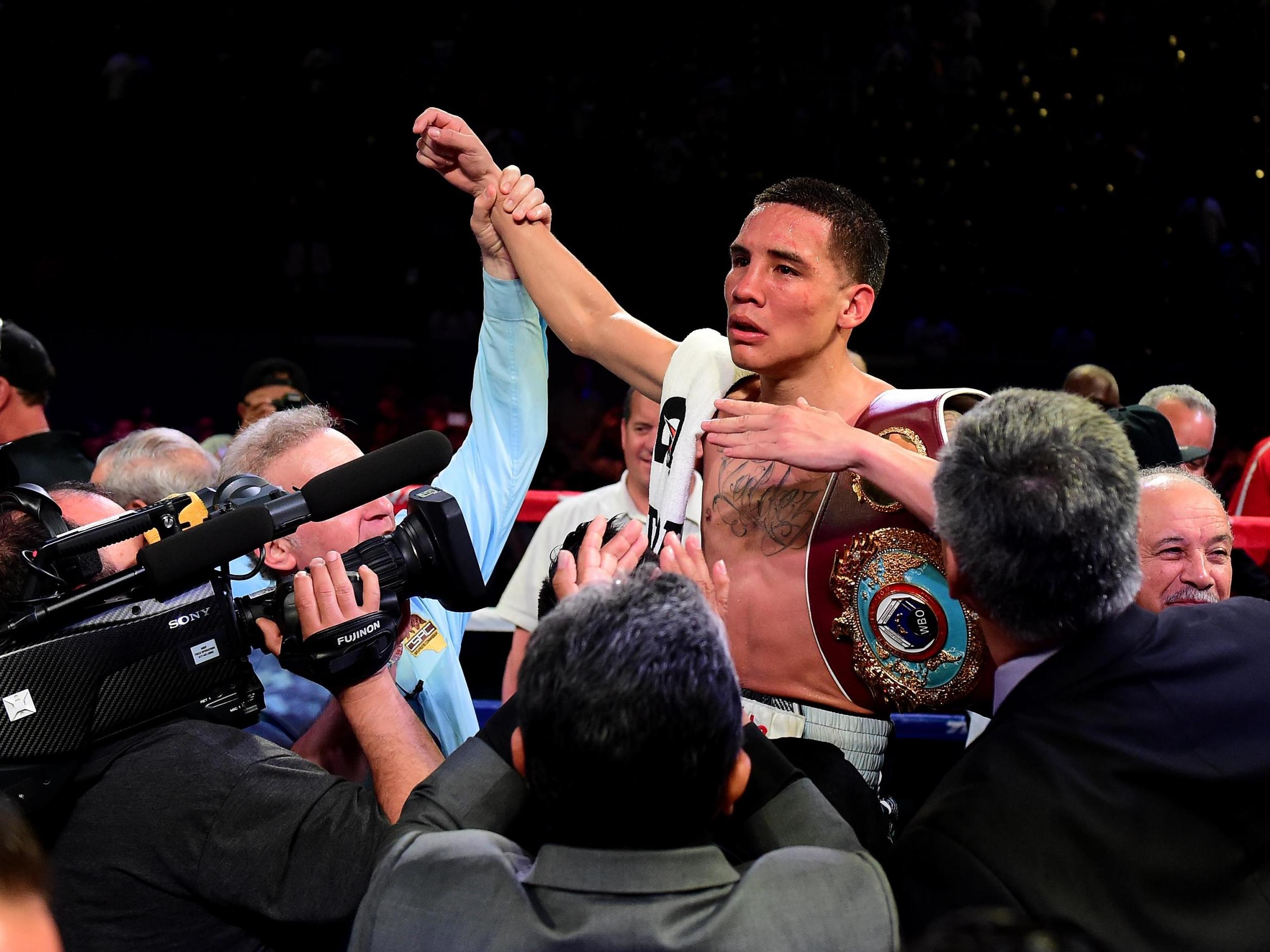 Oscar Valdez celebrates after defeating Miguel Marriaga in 2017