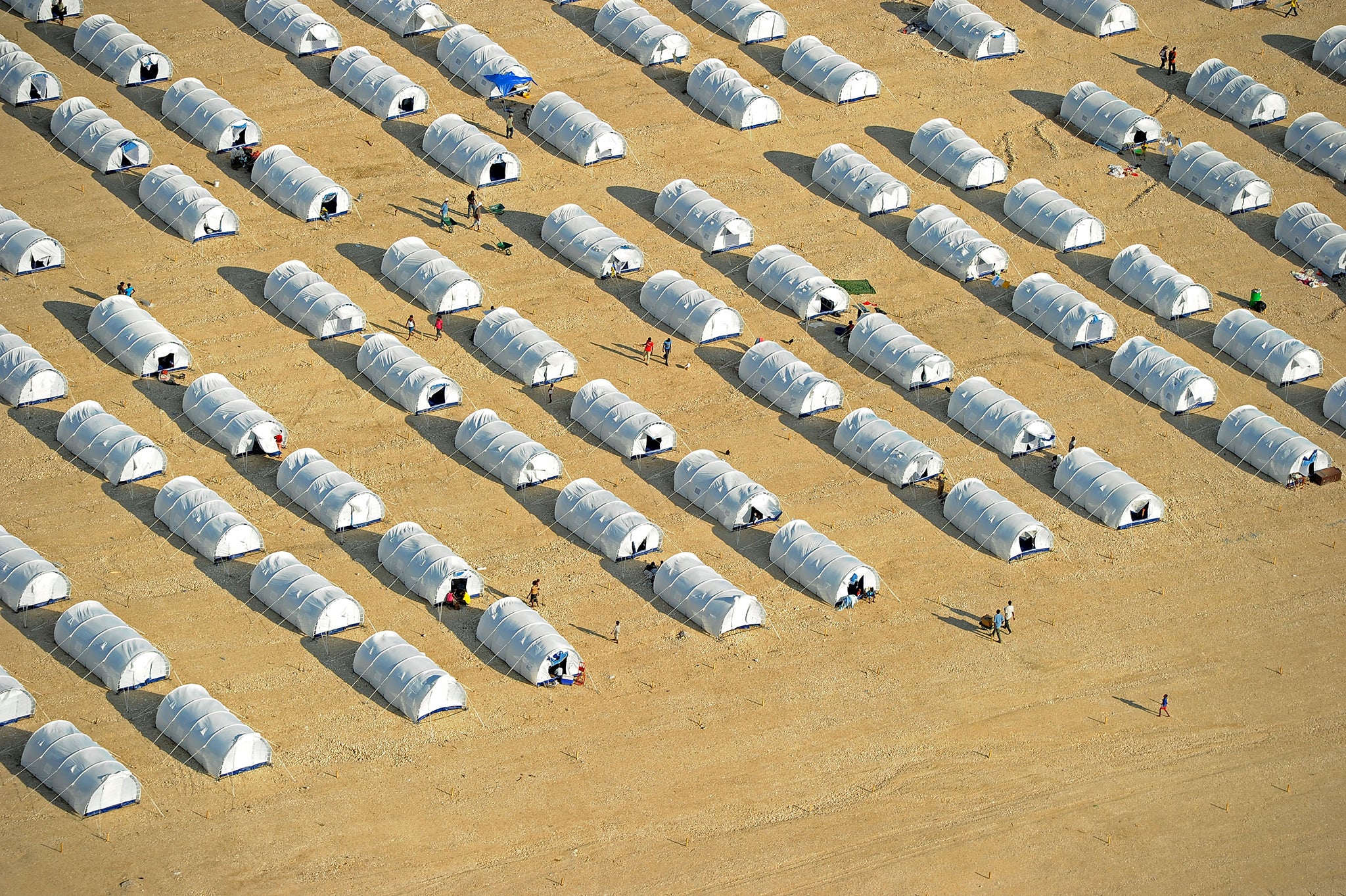 A large tent city set up to relocate earthquake survivors to higher ground due to risks of flooding and landslides