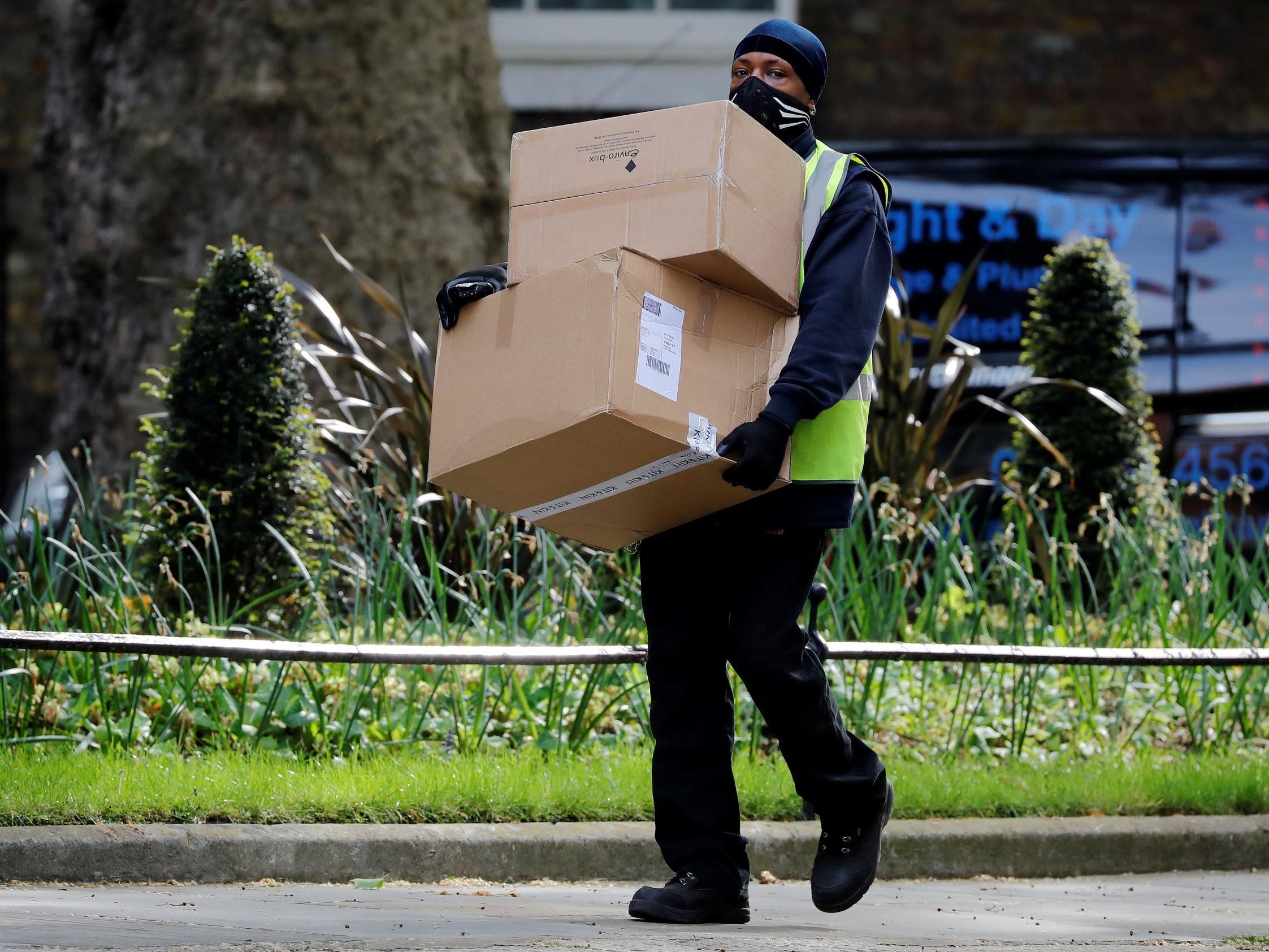 A Hermes delivery courier carries boxes as he makes a delivery to Downing Street