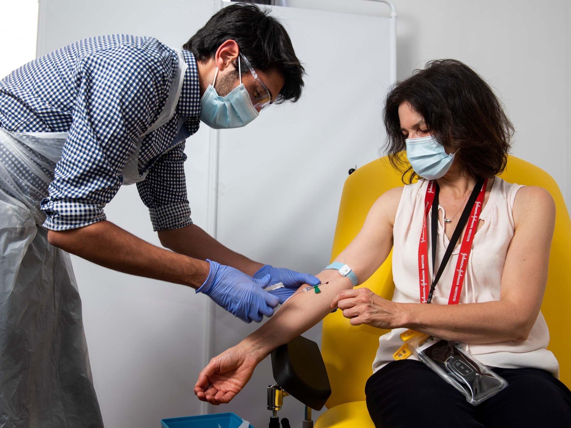 A doctor takes blood samples for use in a University of Oxford coronavirus vaccine trial.