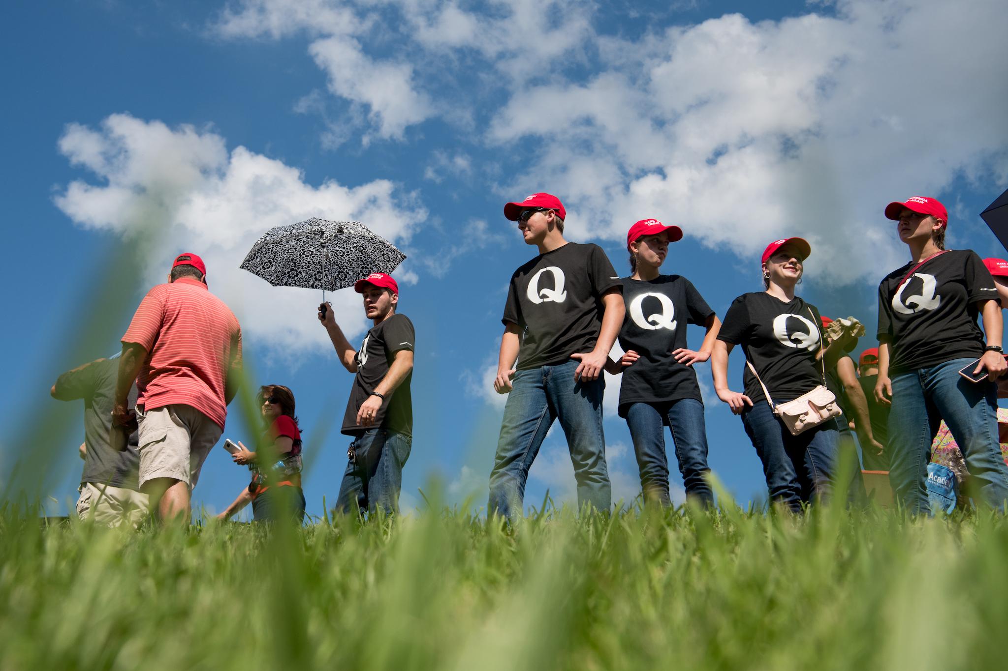 Supporters of President Donald Trump wearing 'QAnon' t-shirts wait in line before a campaign rally at Freedom Hall on October 1, 2018 in Johnson City, Tennessee