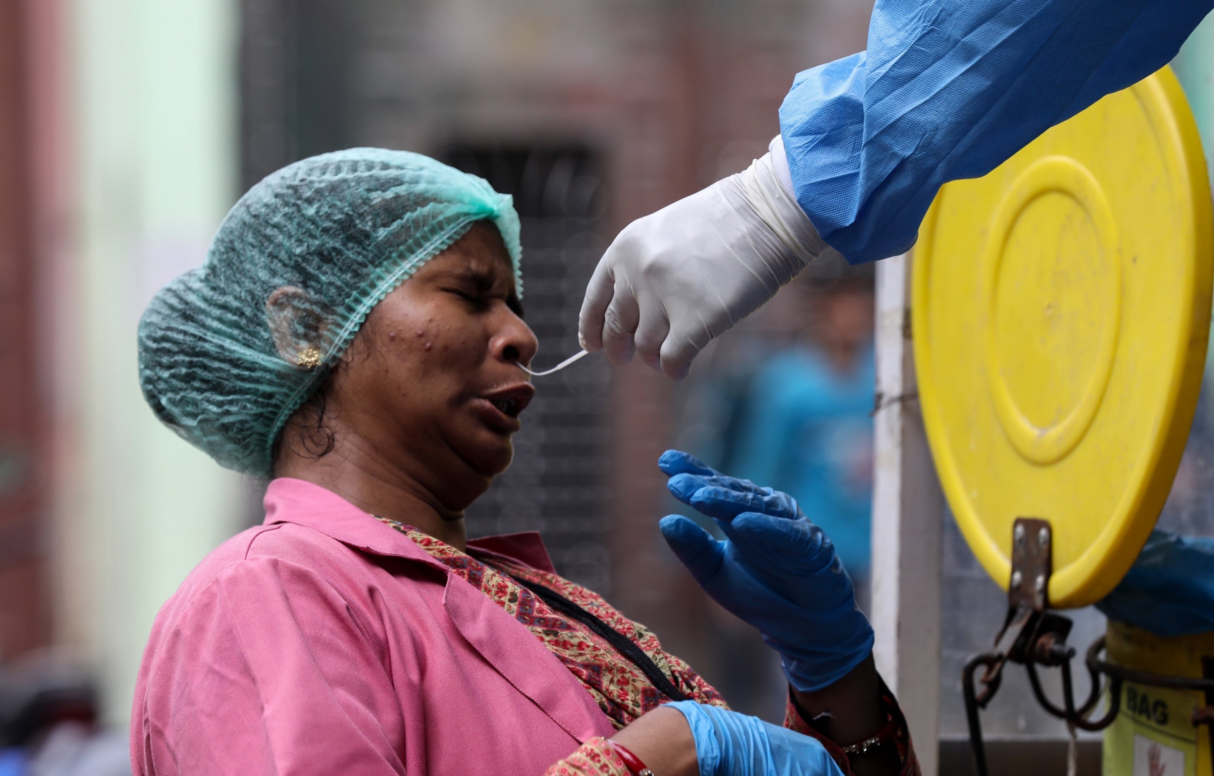 Health worker collects swab samples for coronavirus in New Delhi