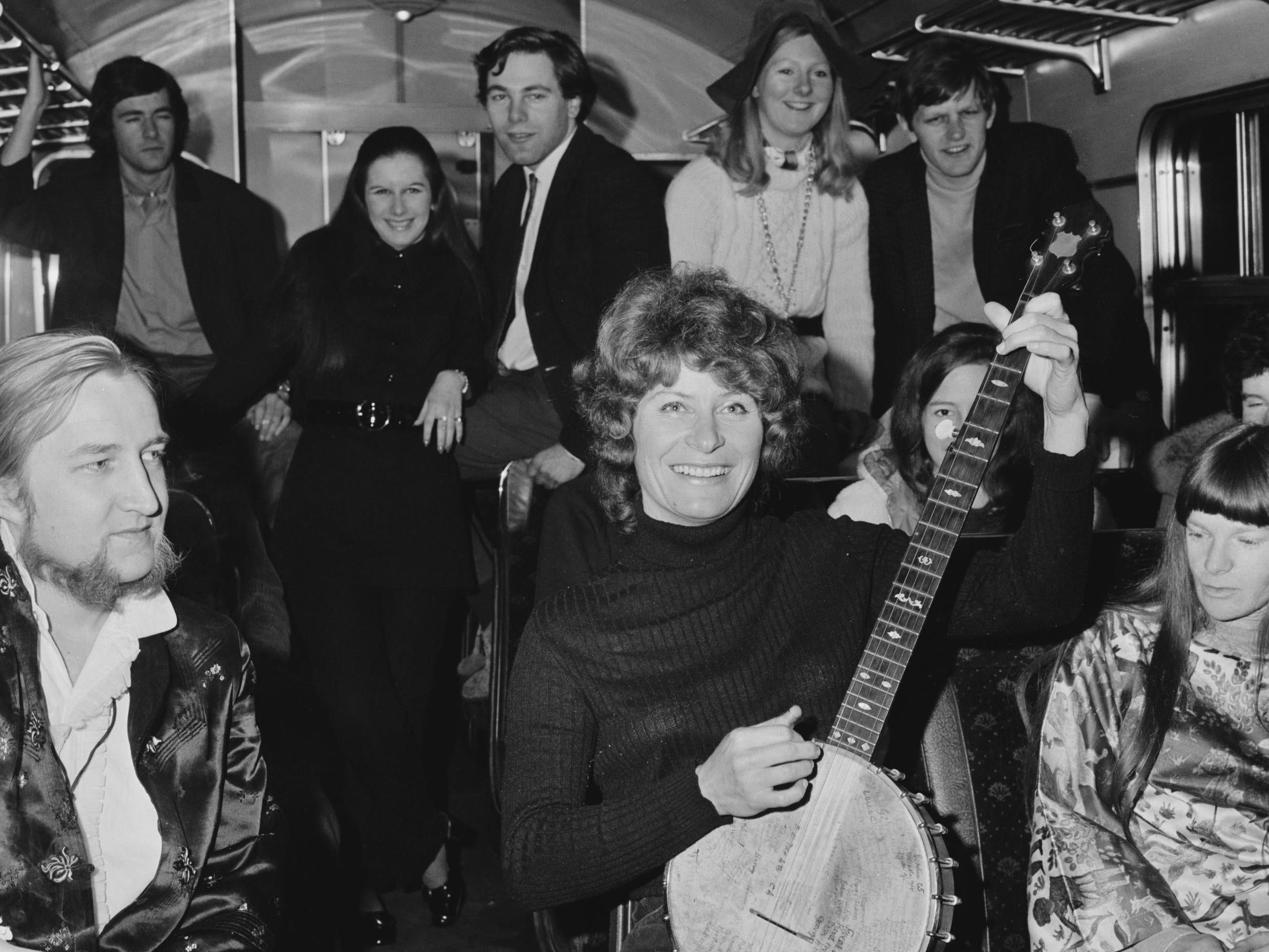 Shirley Collins poses with passengers on a train in June 1970 (Getty)