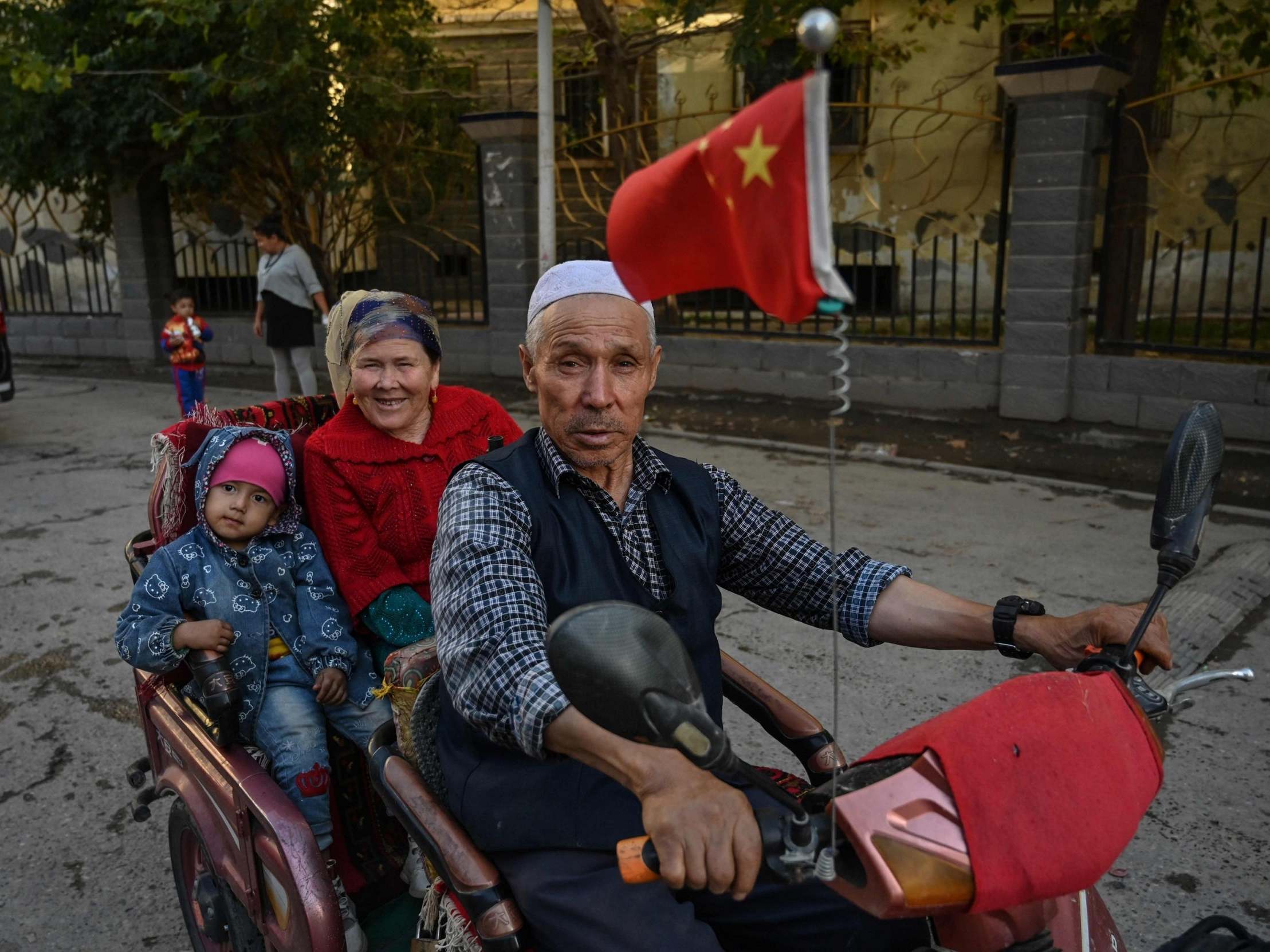 A man driving a vehicle in an Uighur neighbourhood in Xinjiang province