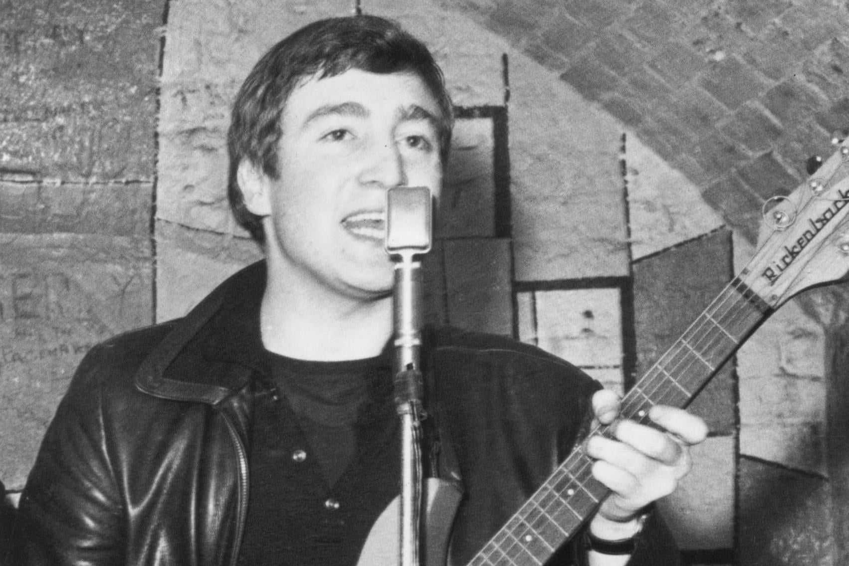 Lennon live on stage at the Cavern Club in Liverpool in 1961, four months before Sutcliffe’s death