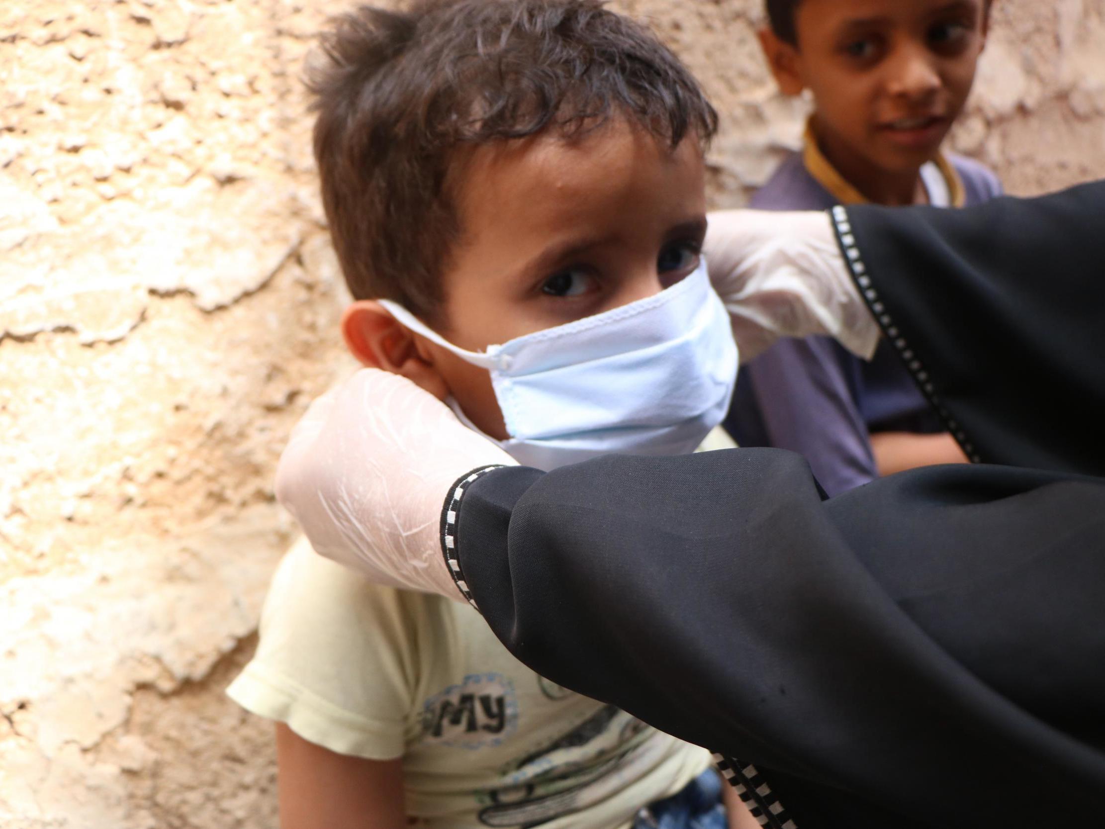 Children are shown how to use masks to avoid spreading Covid-19