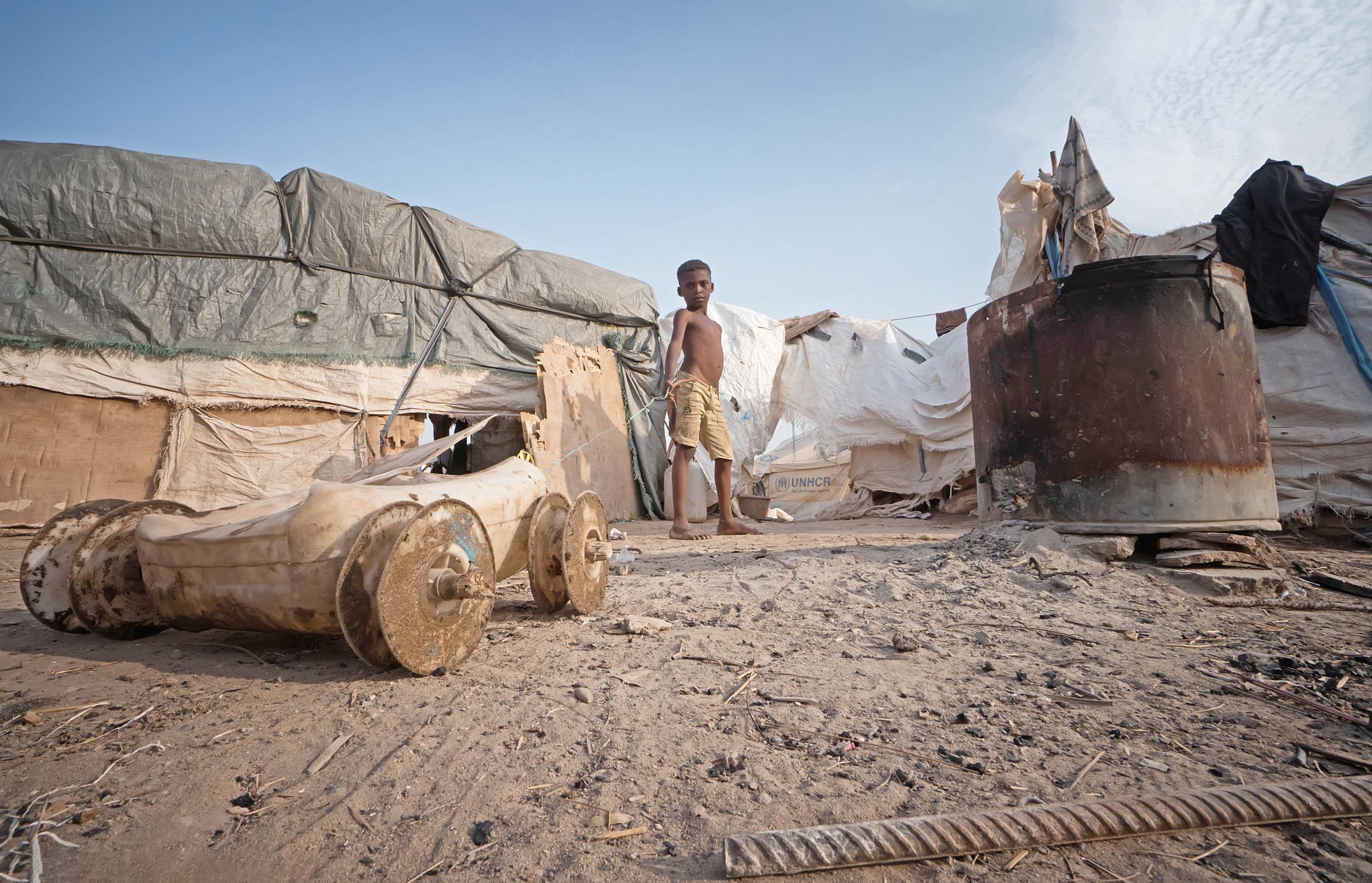 A boy poses for a picture in a camp in Yemen. He fled the war with his family in Taiz governorate. They have lived in the camp for more than two years and lack all of the most basic essentials, including food, clean water, toilets and access to healthcare