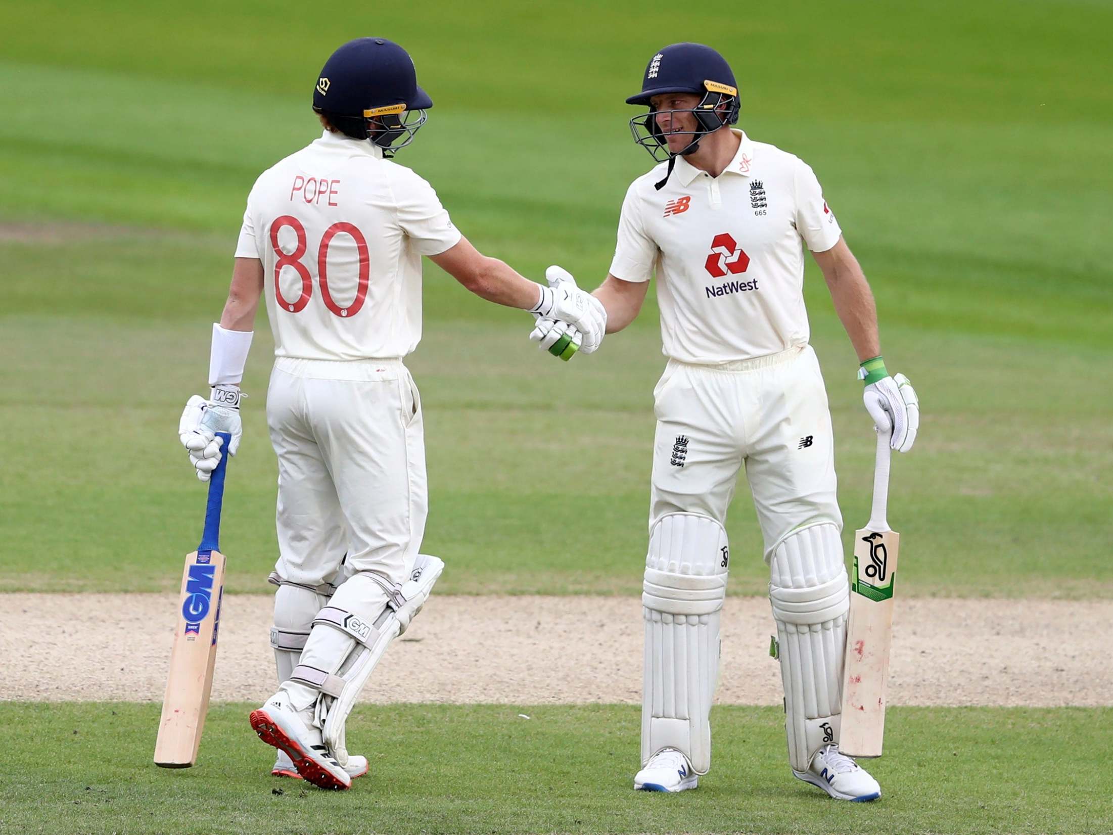 Jos Buttler congratulates Ollie Pope on his half-century