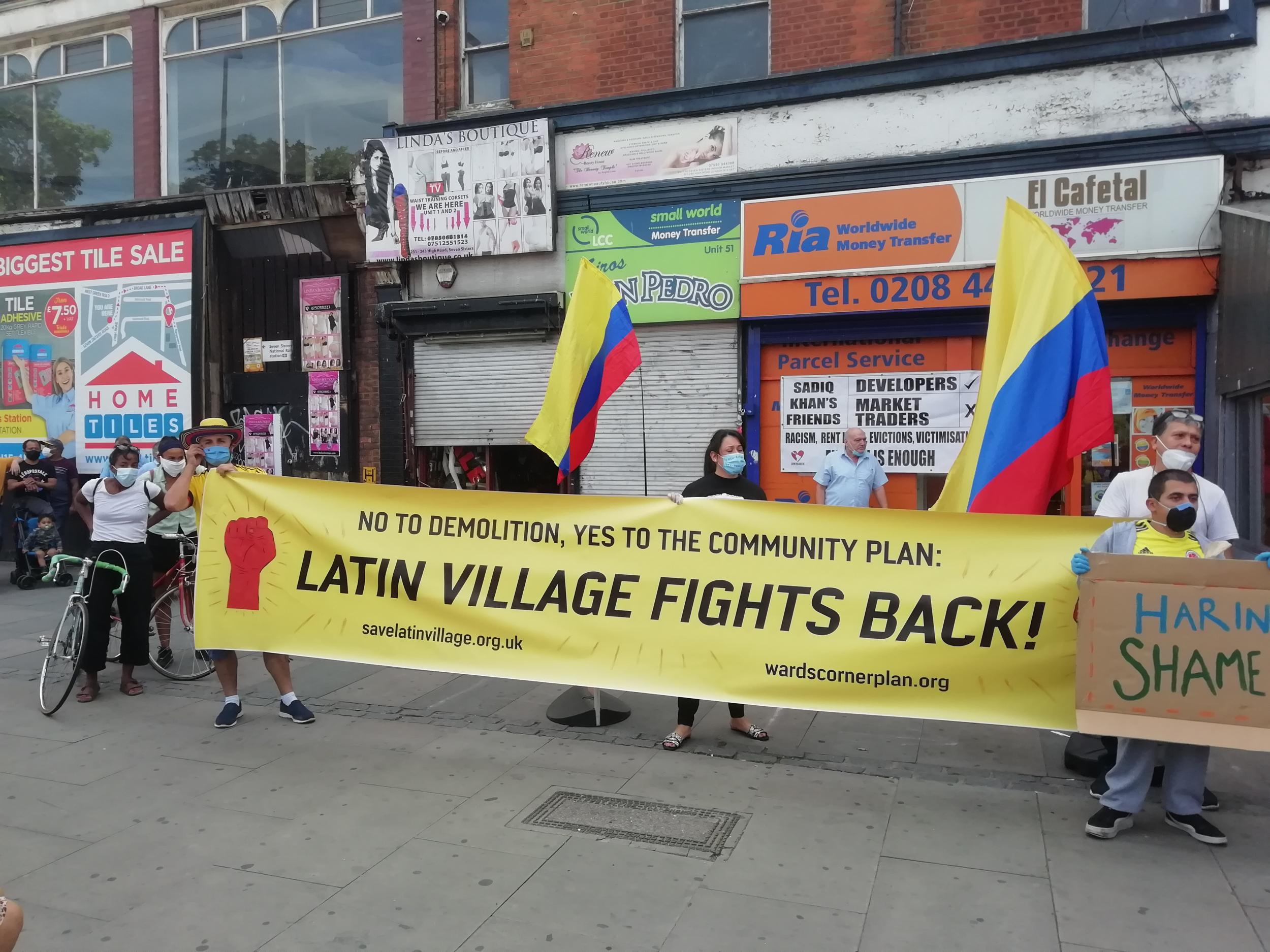 Protesters hold up a banner outside the market, amid growing fears the gentrification of the area could see it closed for good