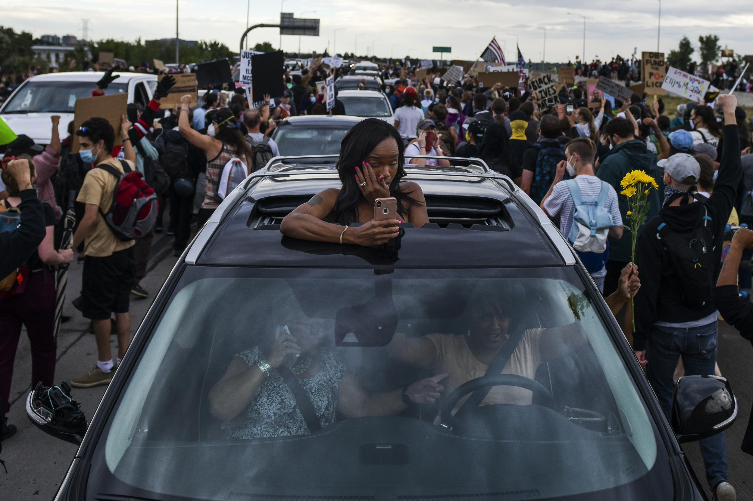 Demonstrators were walking on Interstate 225 in the Denver suburb of Aurora on Saturday when a vehicle drove through, police said