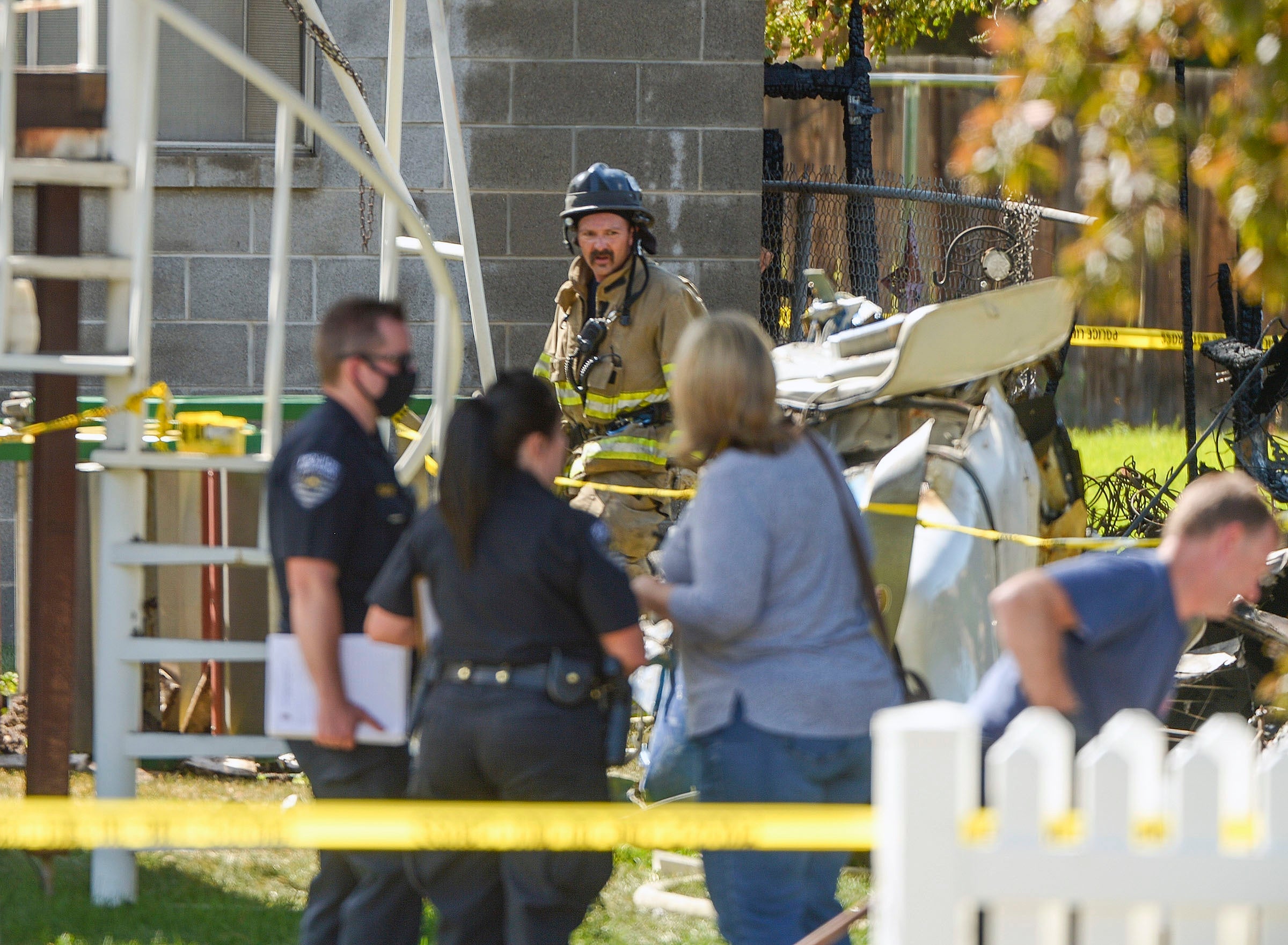 Emergency crews respond to a small plane crash in the back yard of a home in West Jordan, Utah