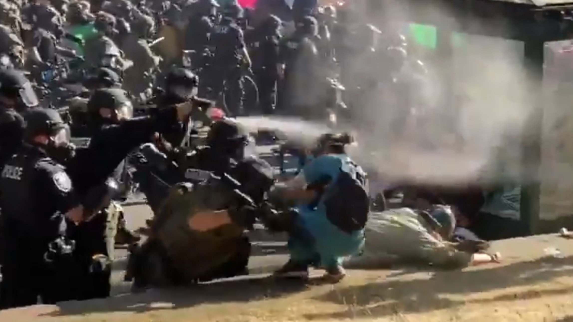 A nurse has tear gas fired into her face while trying to help a protester who had been pushed over by police during a demonstration for racial justice in Seattle