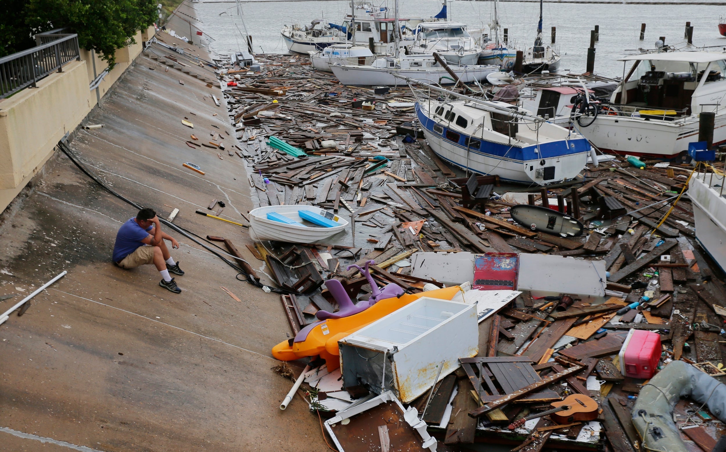 Allen Heath surveys the damage to a private marina in Corpus Christi, Texas after it was hit by Tropical Storm Hanna, which was downgraded from a hurricane as it hit land