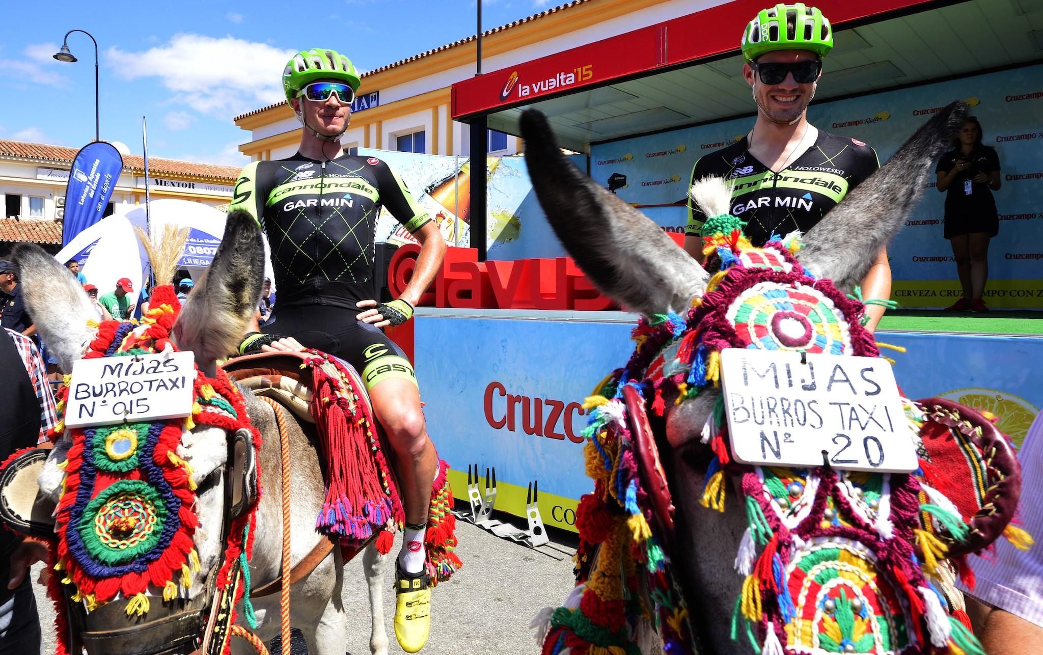 Cannondale-Garmin cyclists US Alex Howes (R) and US King Benjamin pose on the back of donkeys before the third stage of the 2015 Vuelta Espana cycling tour, a 158.4km stage between Mijas and Malaga on August 24, 2015