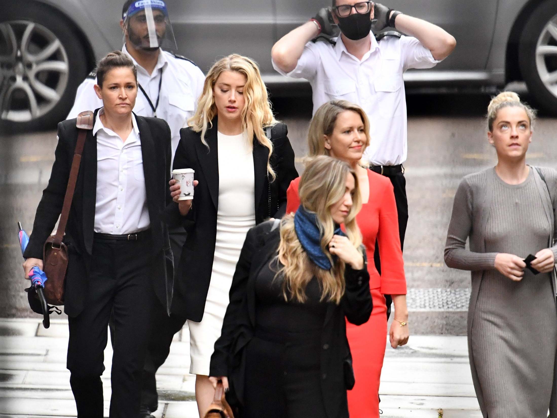 Amber Heard and girlfriend Bianca Butti, left, arrive at the Royal Courts of Justice, London, on 27 July (Gareth Cattermole/Getty)