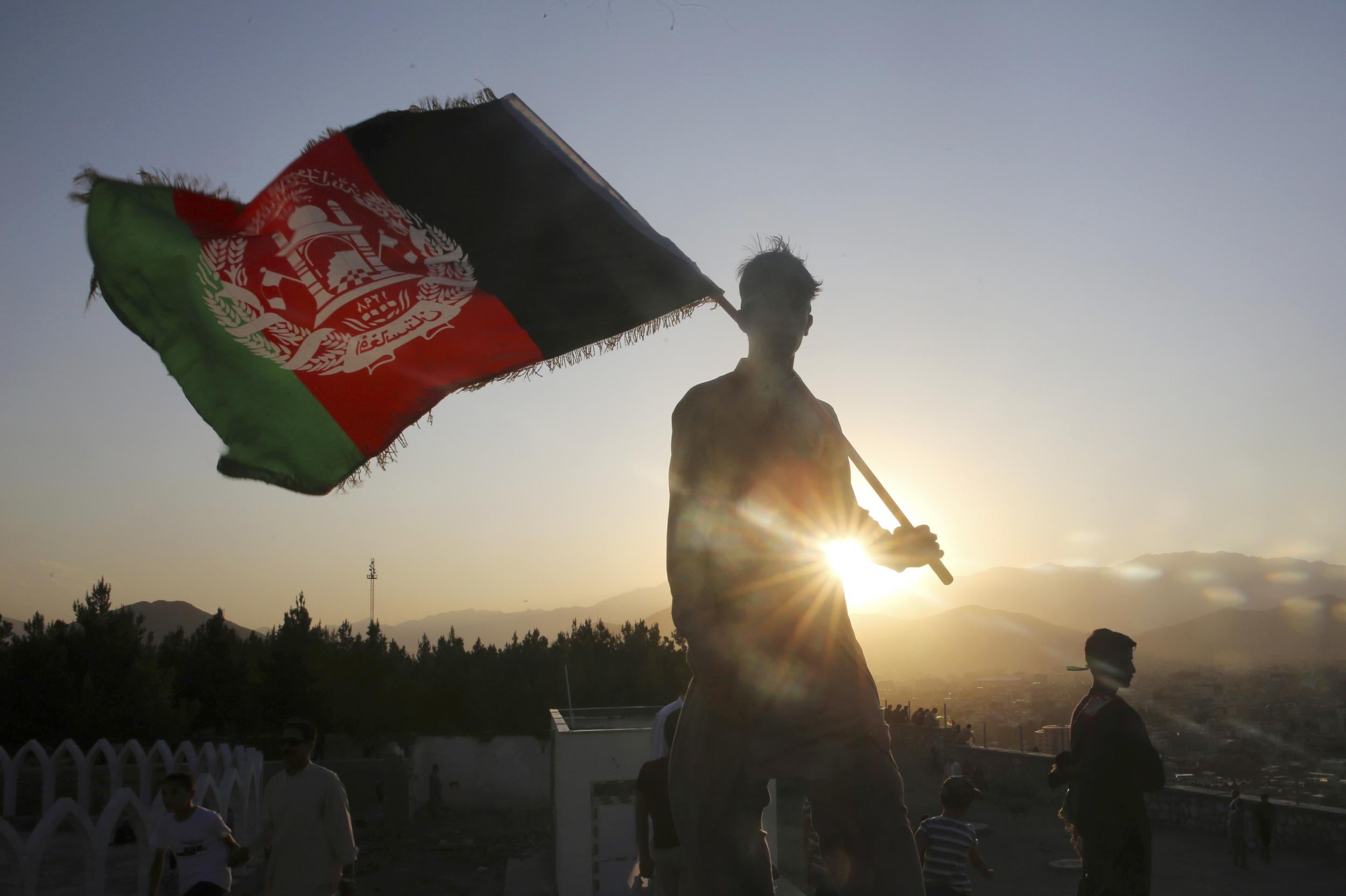 The Afghan national flag is waved during Independence Day celebrations in Kabul in 2019