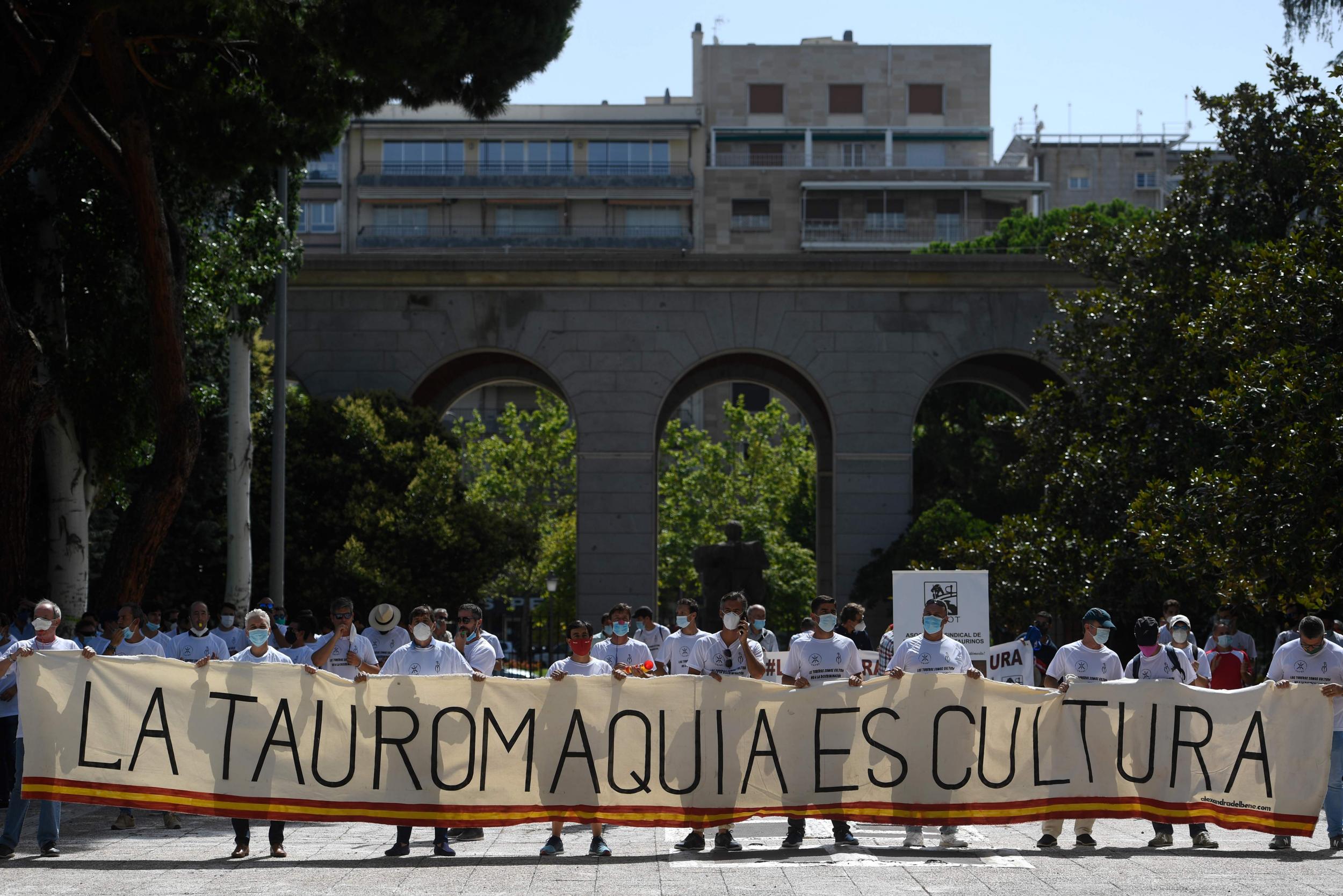 Madrid protesters hold a placard reading “Bullfighting is culture” while demanding more resources on 21 July