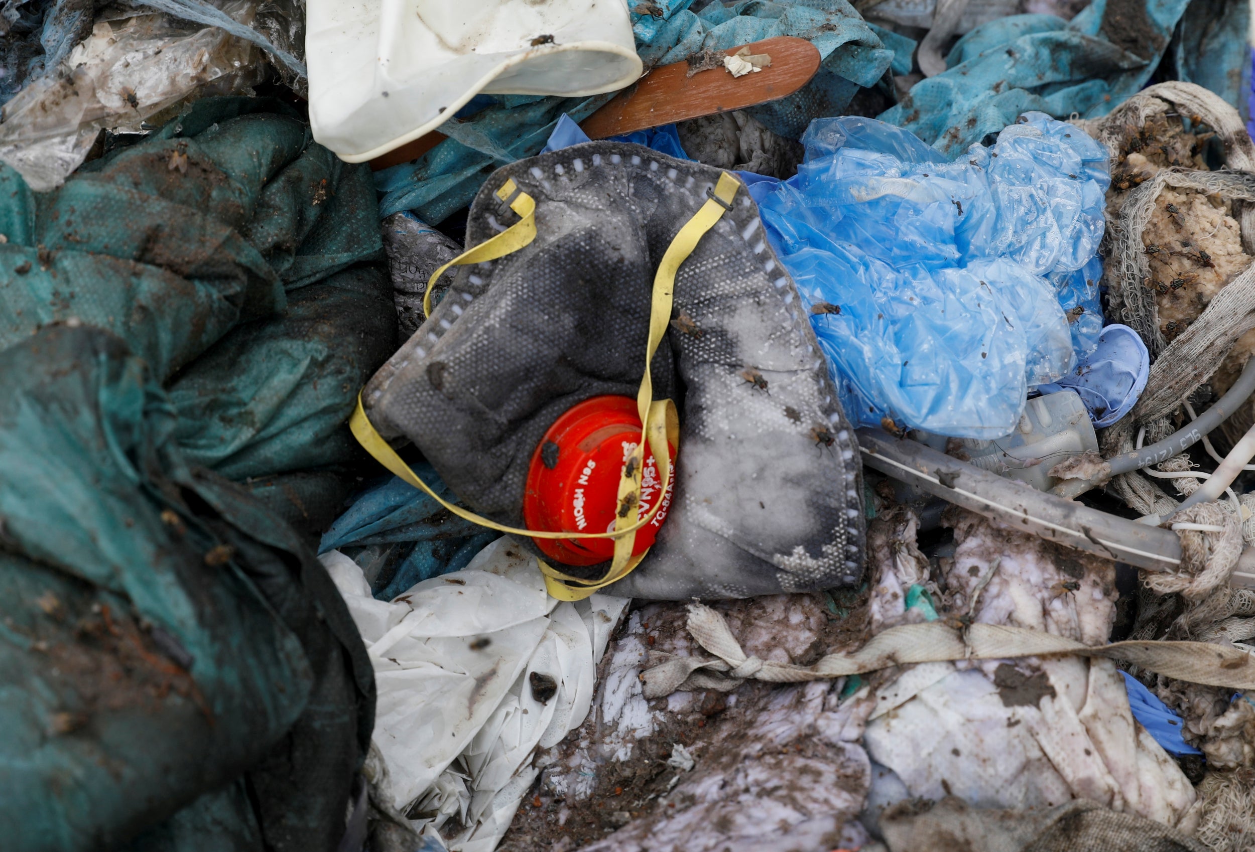 A discarded mask lies among other bits of disposed medical waste (Reuters)