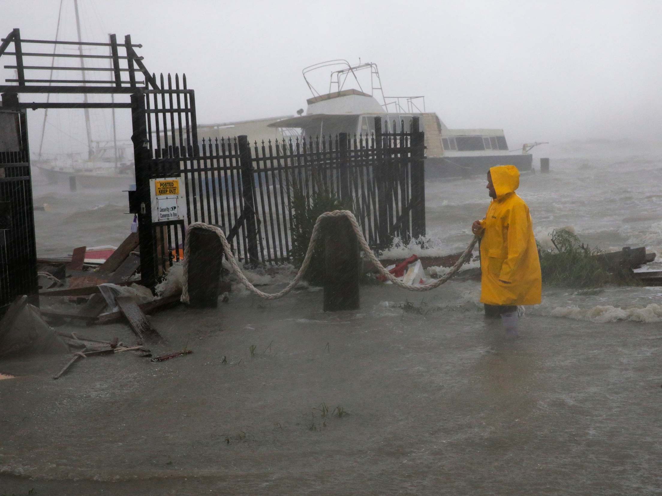 Jame Rowles examines destroyed docks during Hurricane Hanna this month in Corpus Christi, Texas. Coastal flooding is expected to dramatically rise in the coming decades, according to a new study