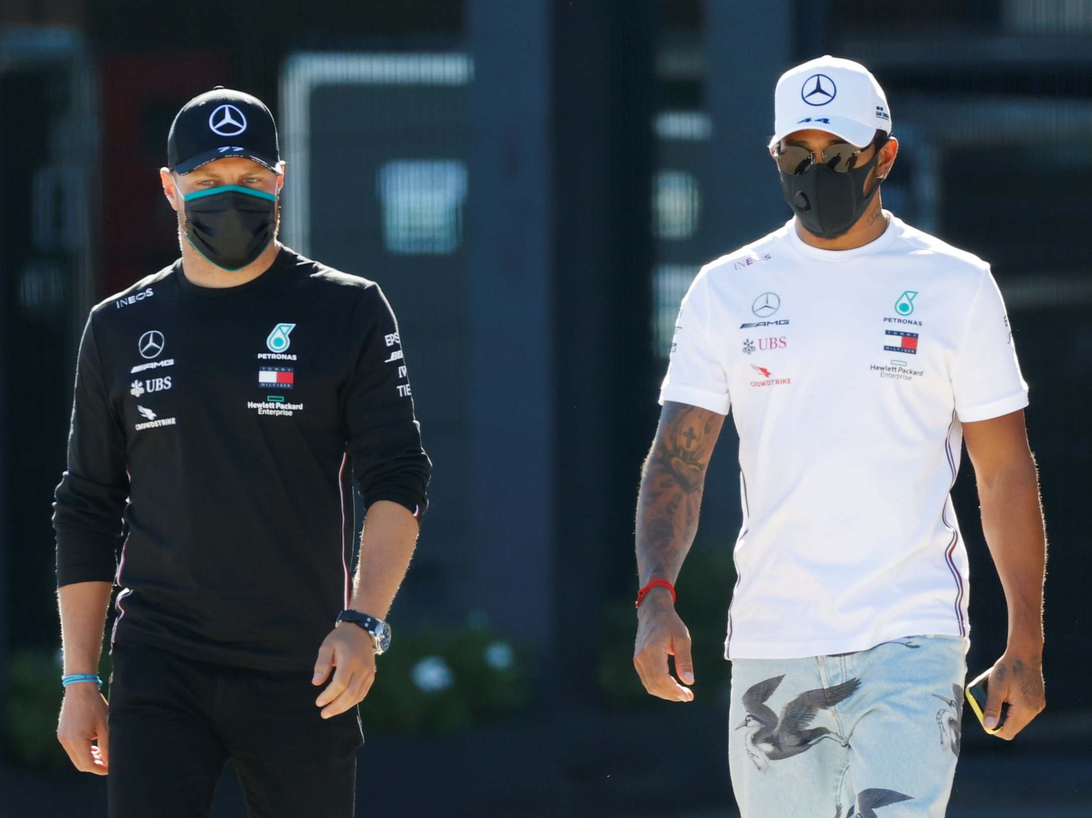 Lewis Hamilton and Valtteri Bottas walk through the Silverstone paddock