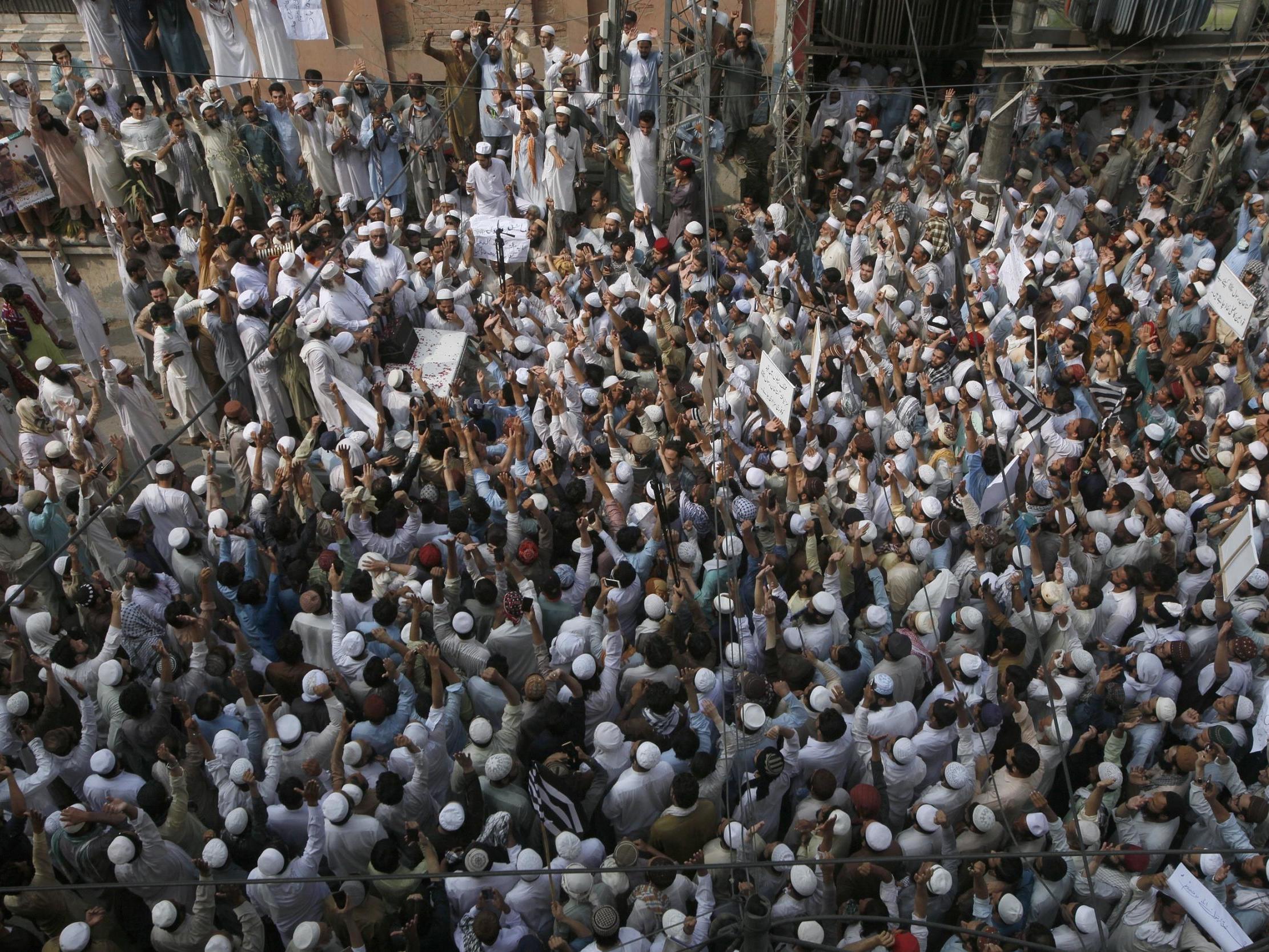 Supporters of a religious group chant slogan during a rally favouring the gunman who shot Tahir Naseem in courtroom, in Peshawar on Friday