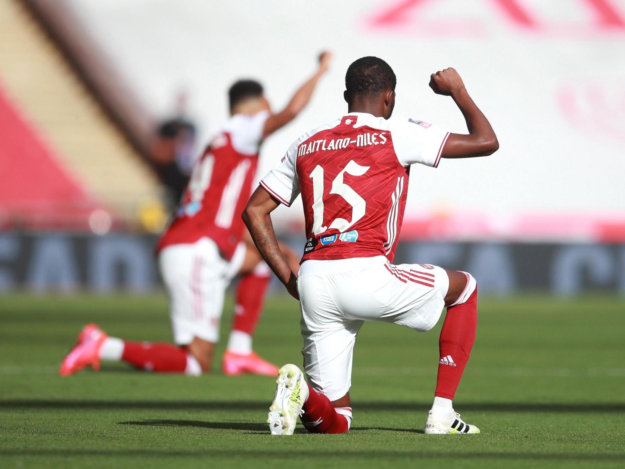 Arsenal’s Ainsley Maitland-Niles takes a knee in support of the Black Lives Matter movement