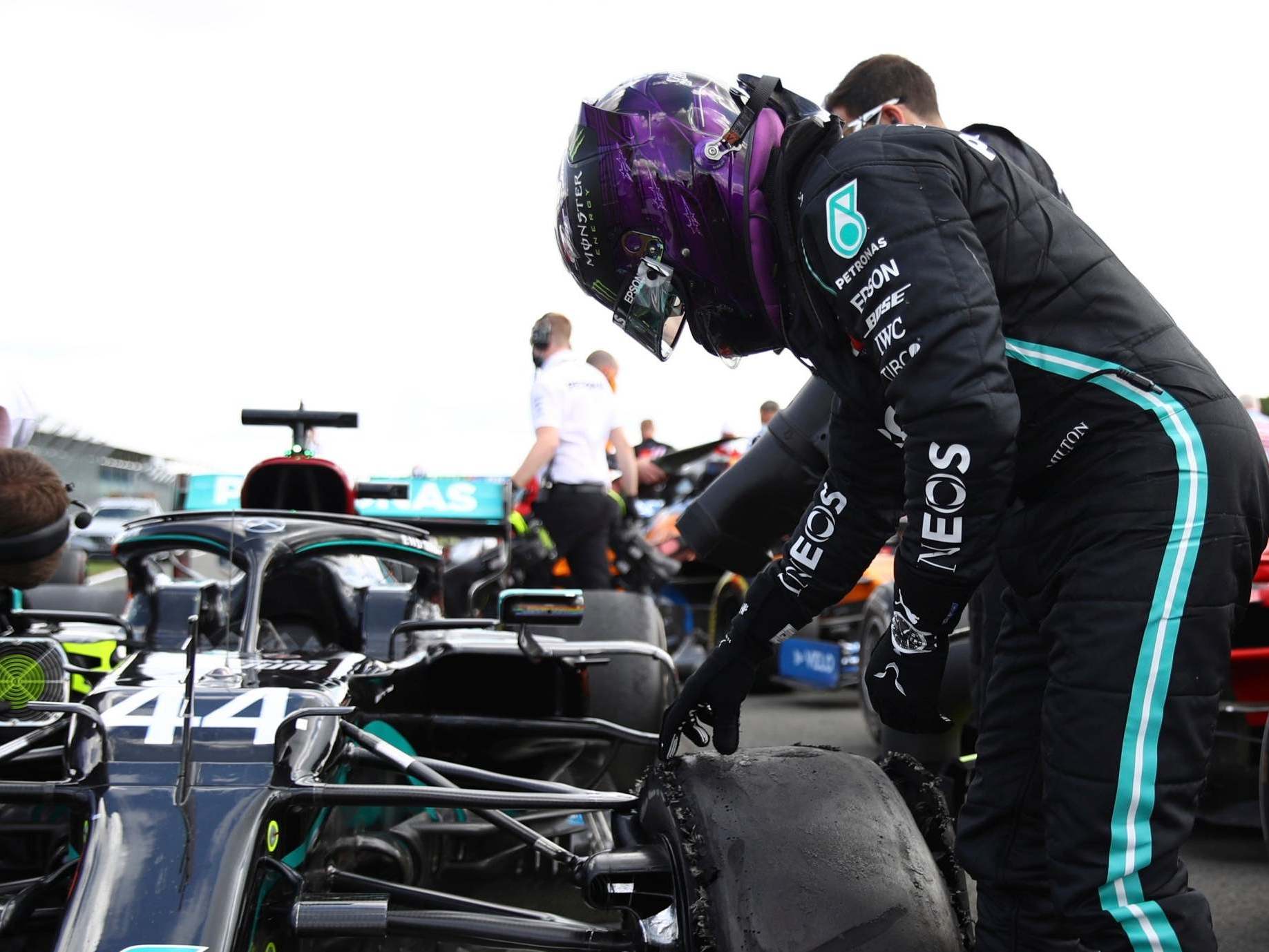 Hamilton inspects his damaged Mercedes after winning the British Grand Prix