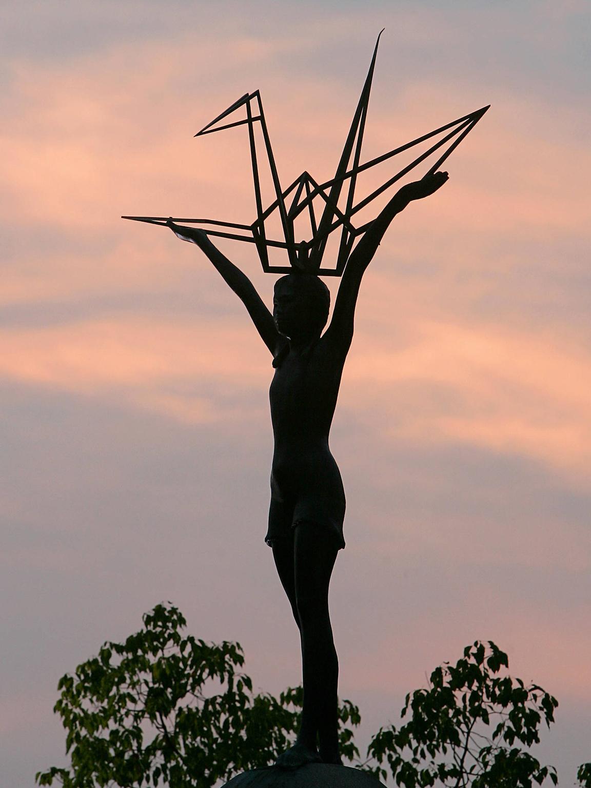 The sun sets behind the Children’s Peace Memorial in Hiroshima