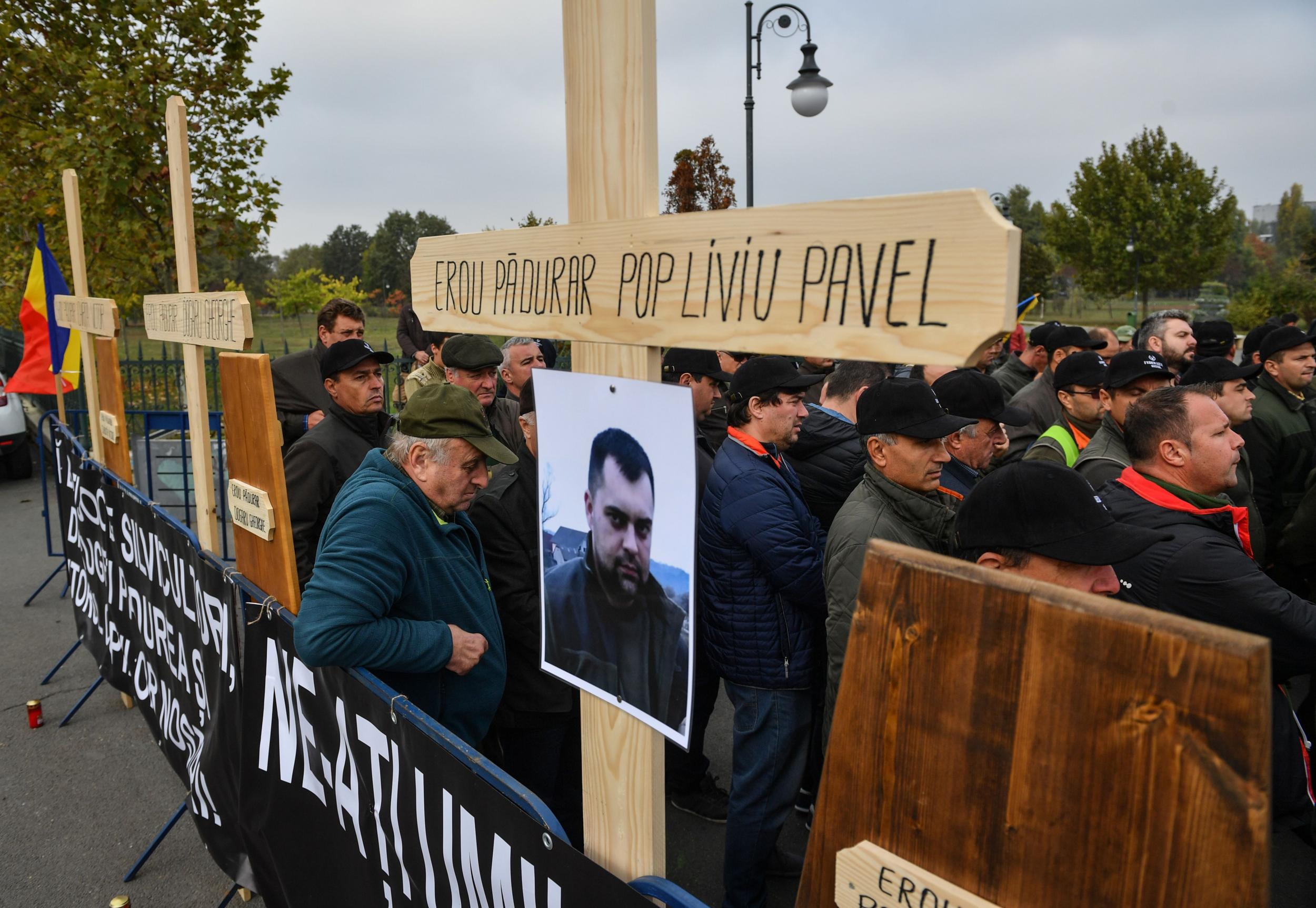 Colleagues of Liviu Pop (pictured) pay tribute after he was shot dead in northern Romania