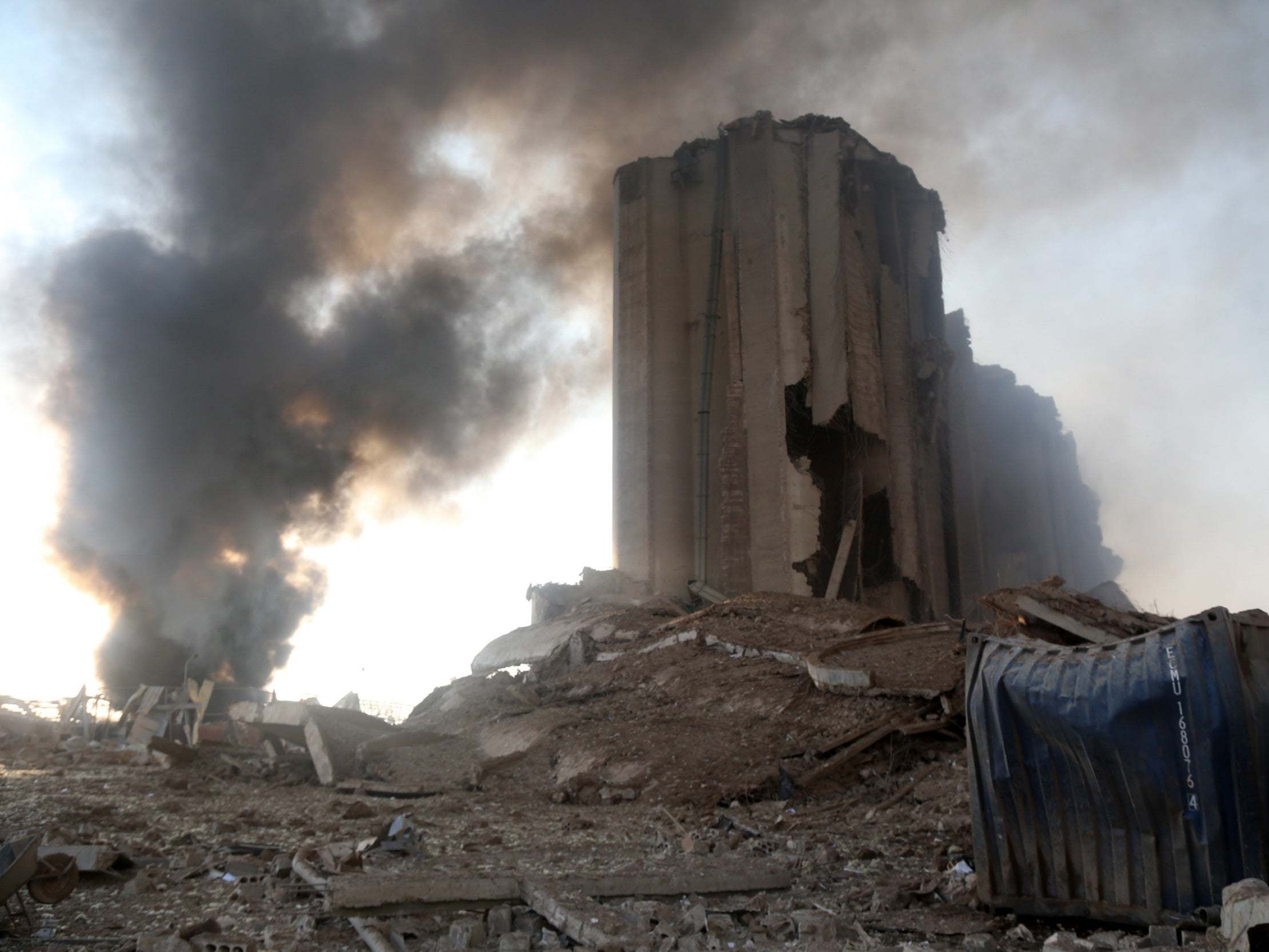 Smoke rises near a destroyed grain silo