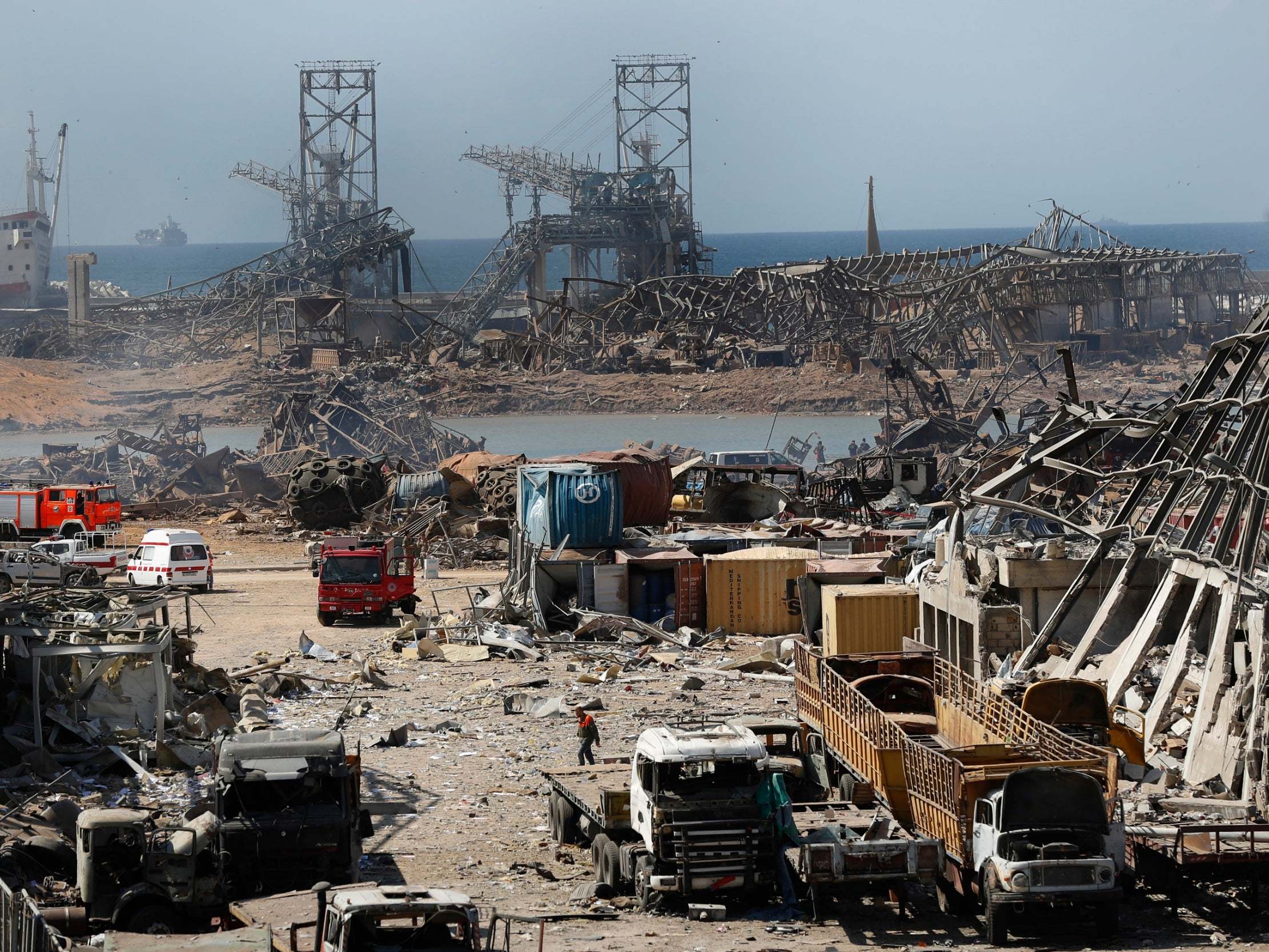 Rescue workers and security officers work at the site of the explosion in Beirut