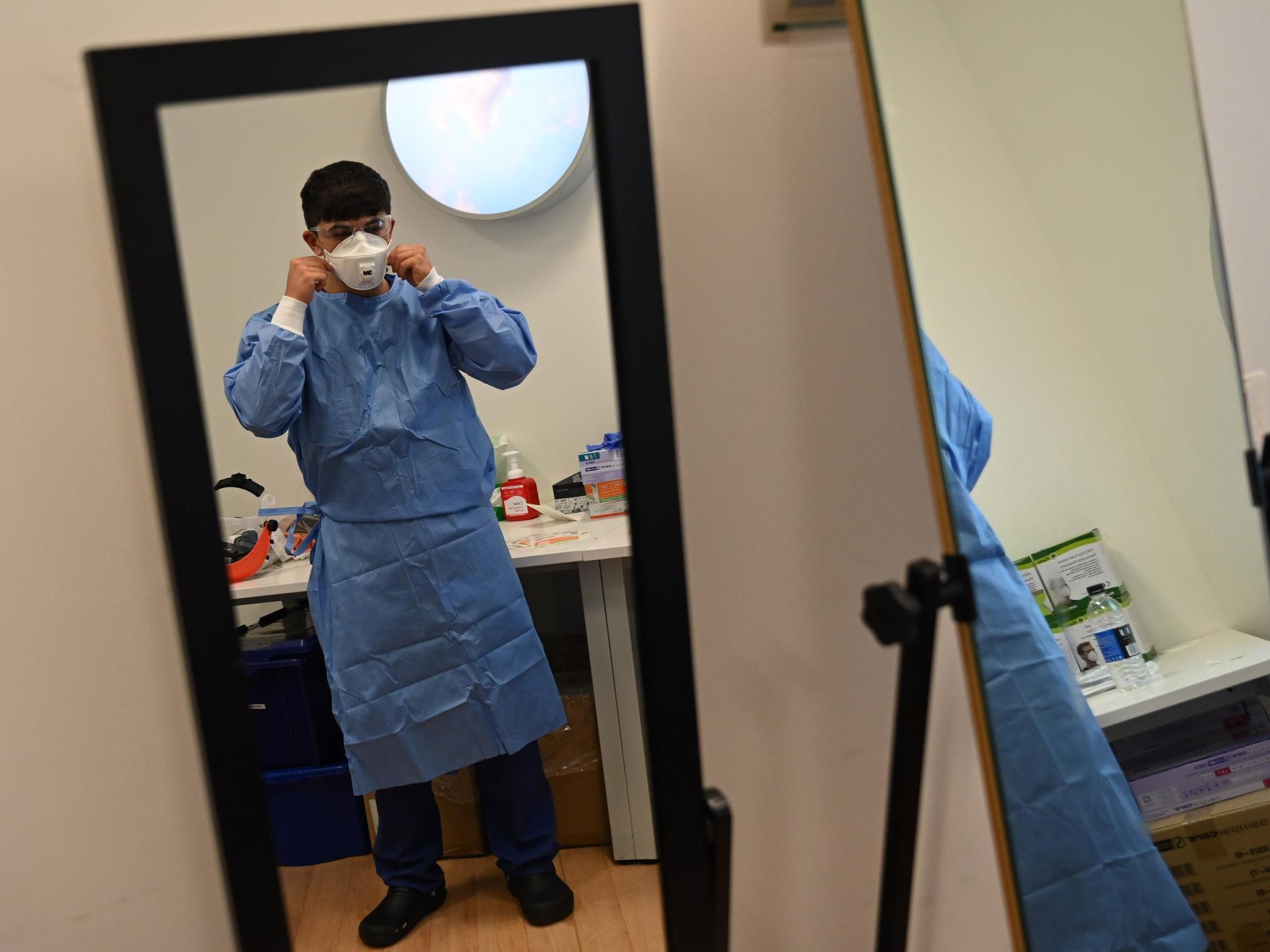 A member of staff adjusts their mask at the Intensive Care unit at Royal Papworth Hospital in Cambridge