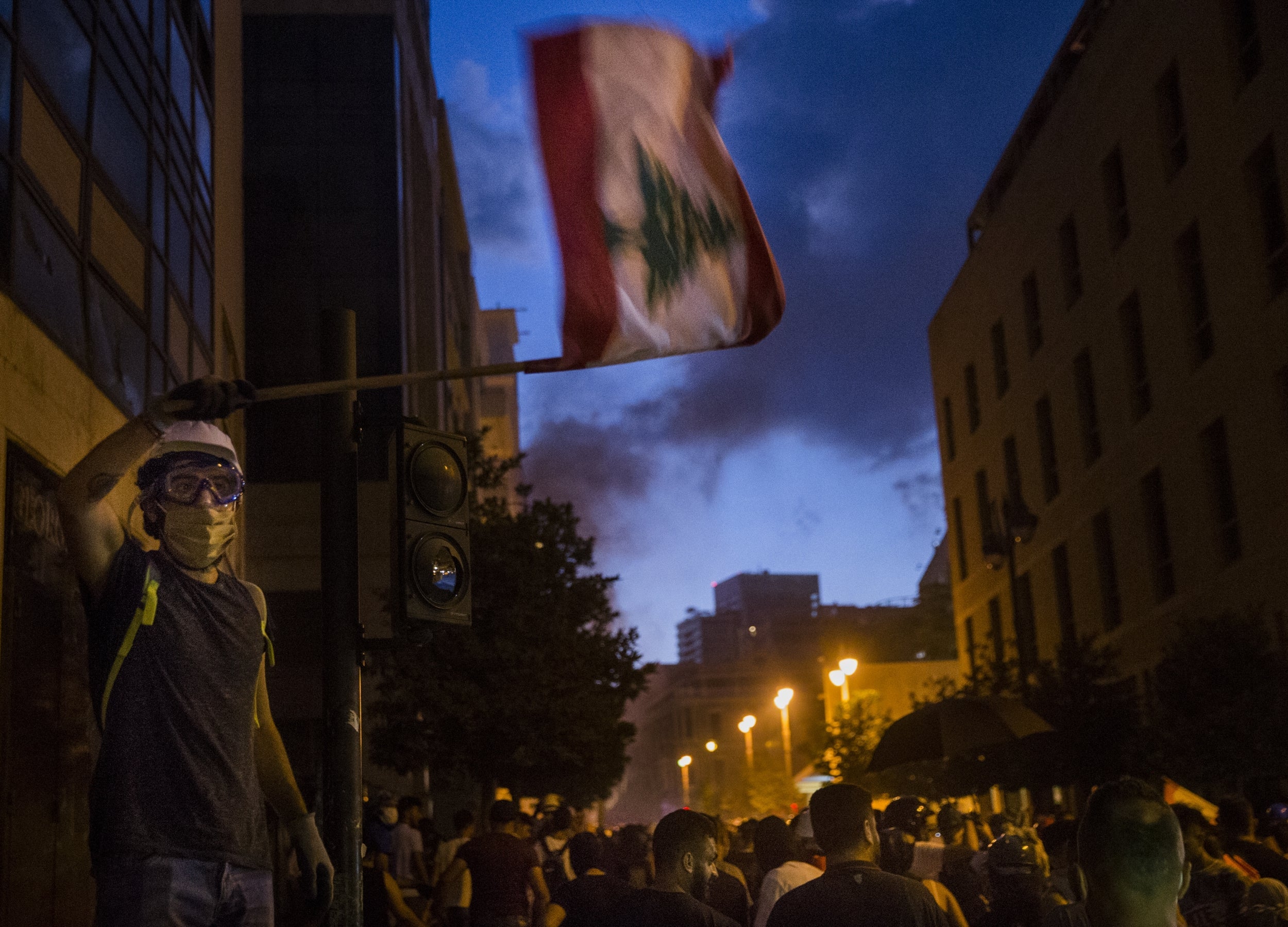 Volunteers clean up rubble from the streets of Beirut after an explosion caused extensive damage in the city