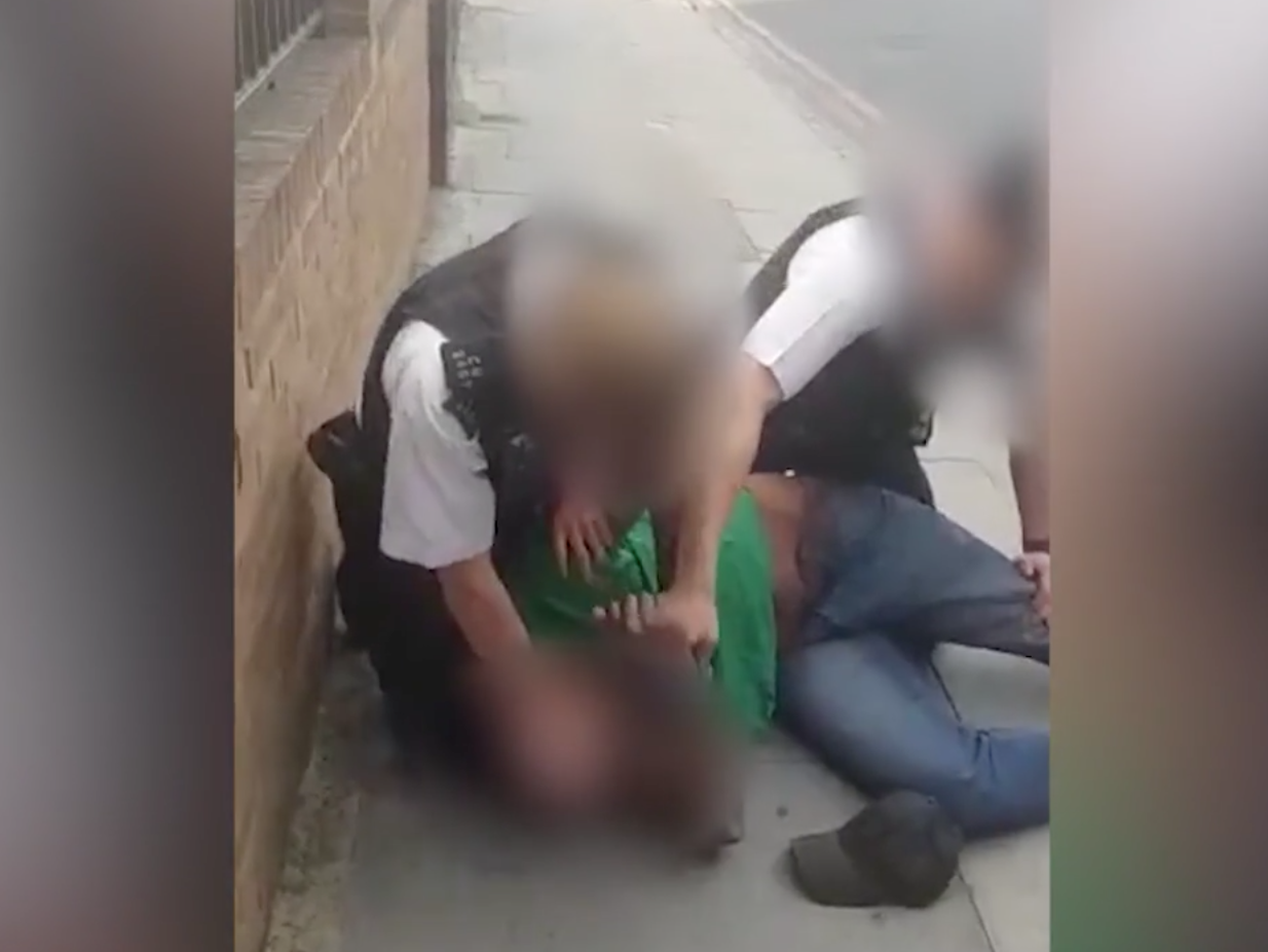 An officer presses his knee into Marcus Coutain’s neck during an arrest in July 2020