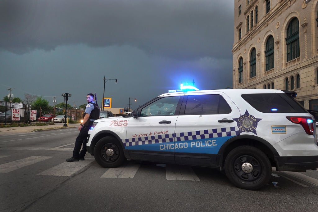 A police officer stands guard following unrest on the city’s westside moments before a derecho storm hits the area on August 10, 2020 in Chicago, Illinois. The storm, with winds gusts close to 100 miles per hour, downed trees and power lines as it moved through the city and suburbs. (Photo by Scott Olson/Getty Images)