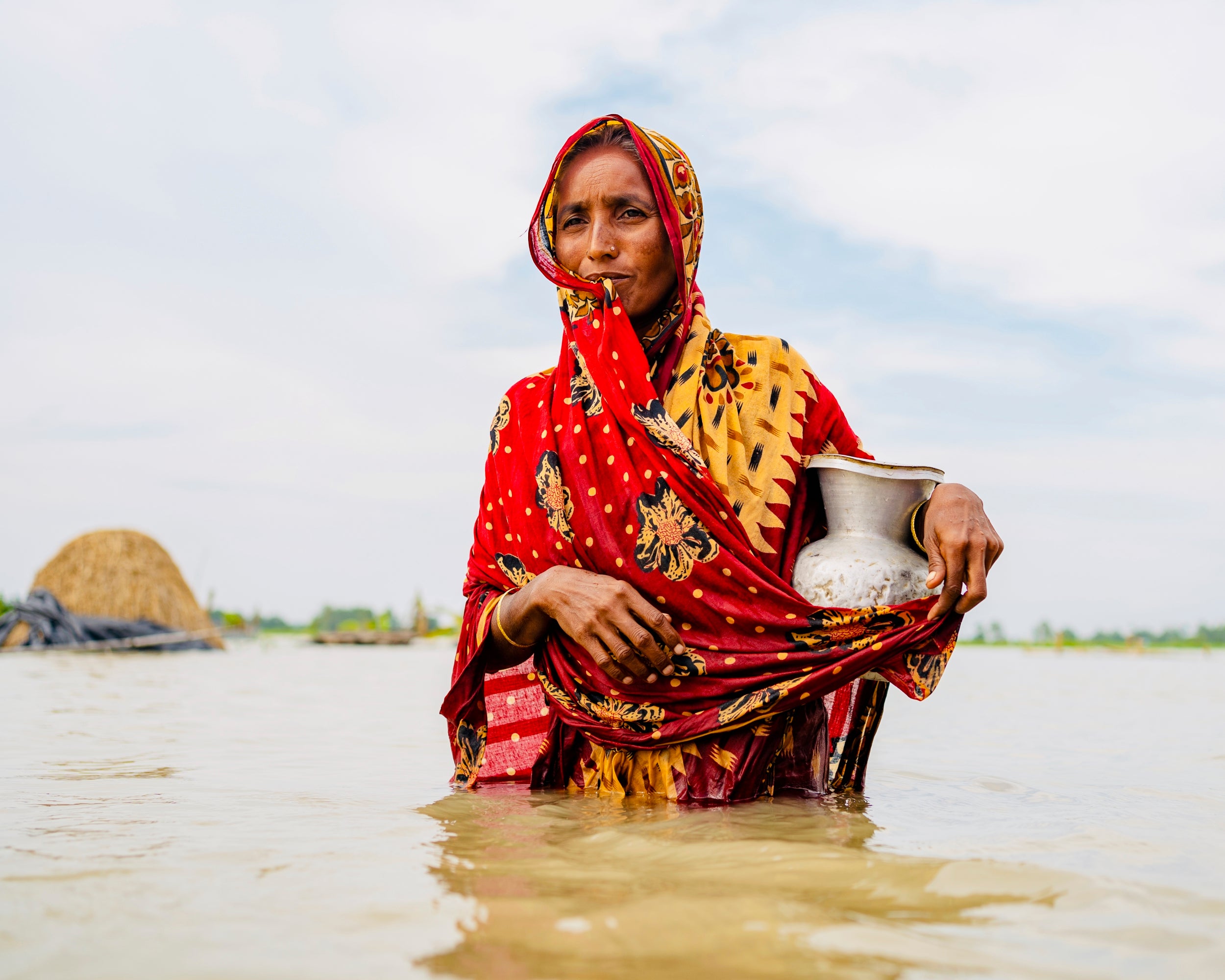 Momotaz Begum carrying a water vessel