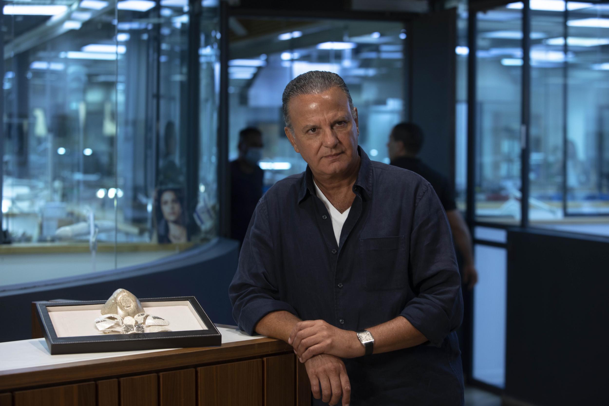 Jeweller Isaac Levy poses near expensive mask (AP/Sebastian Scheiner)