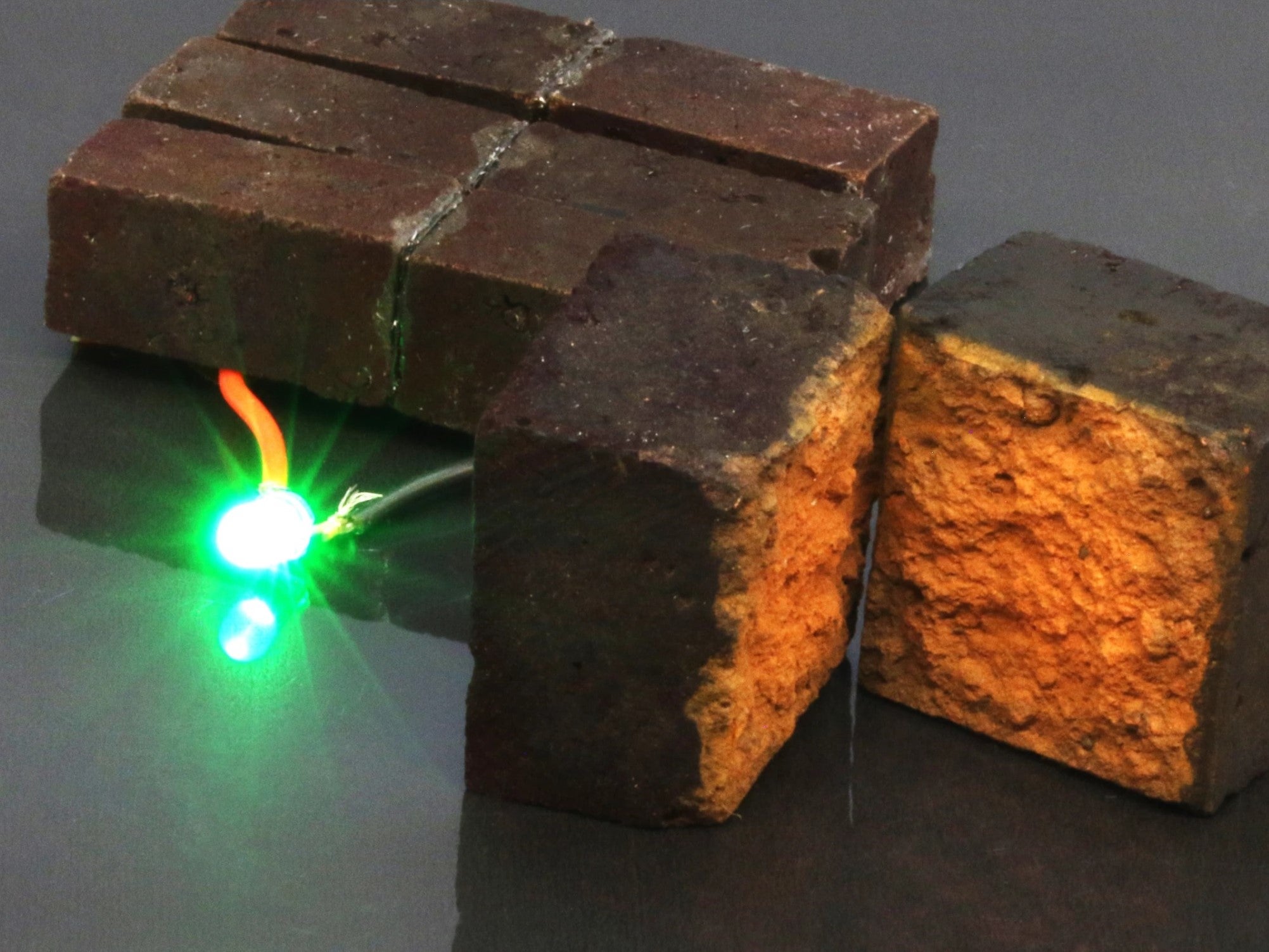 The researchers powered a green LED using their Pedot-coated bricks