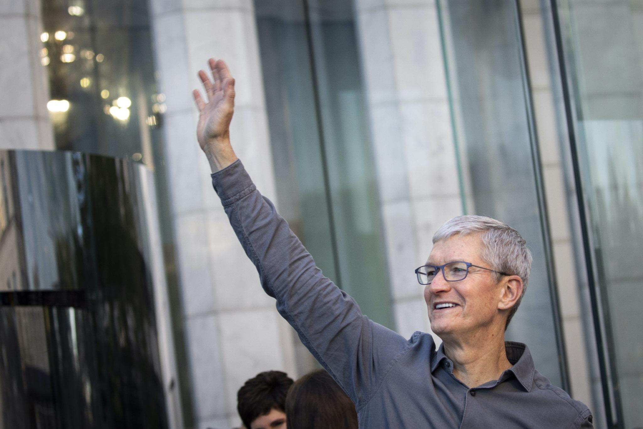 Apple CEO Tim Cook waves to customers before they enter Apple's flagship 5th Avenue store to purchase the new iPhone 11 on September 20, 2019 in New York City