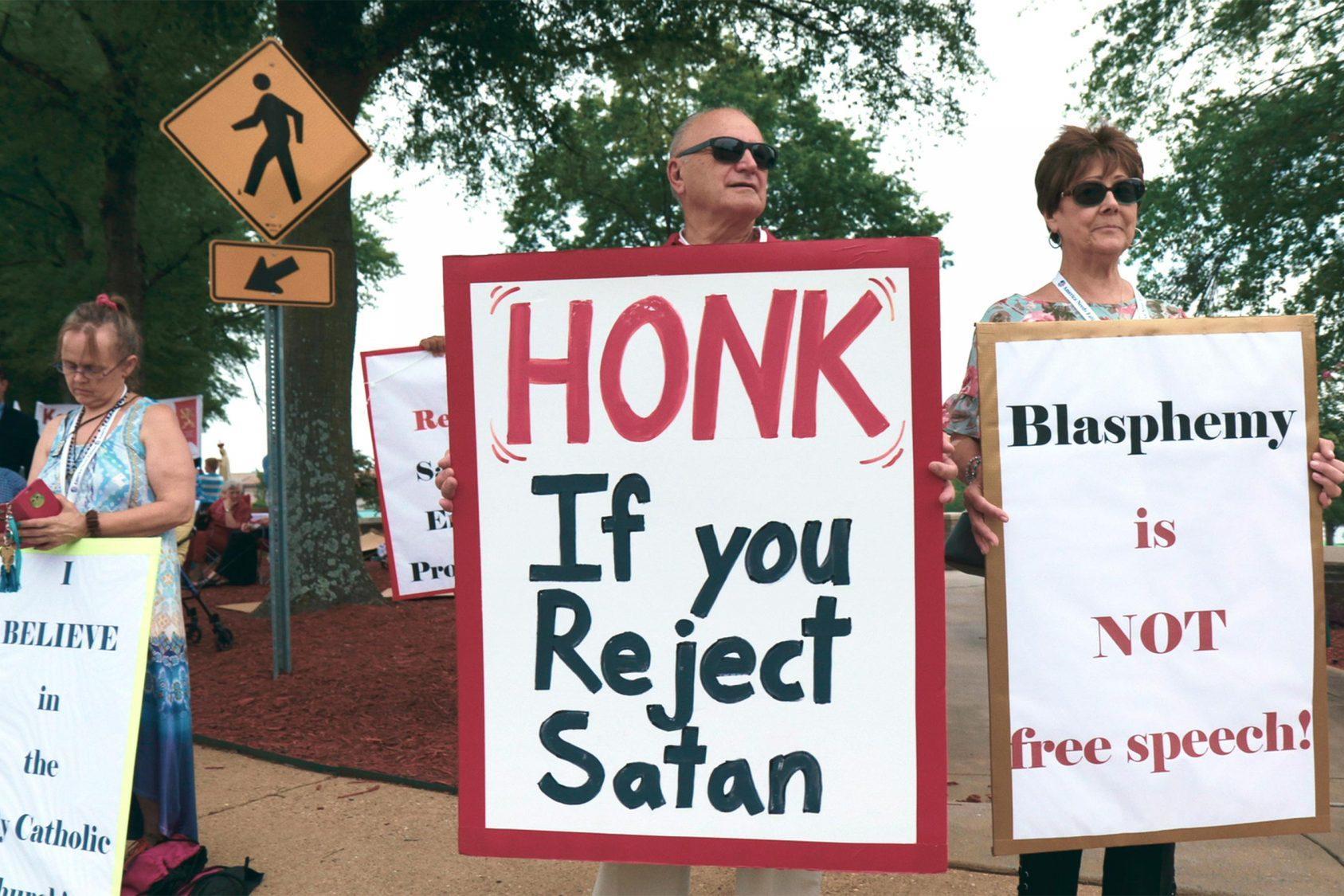 Anti-Satanic Temple protesters square off against their religious opposites at a rally in Arkansas