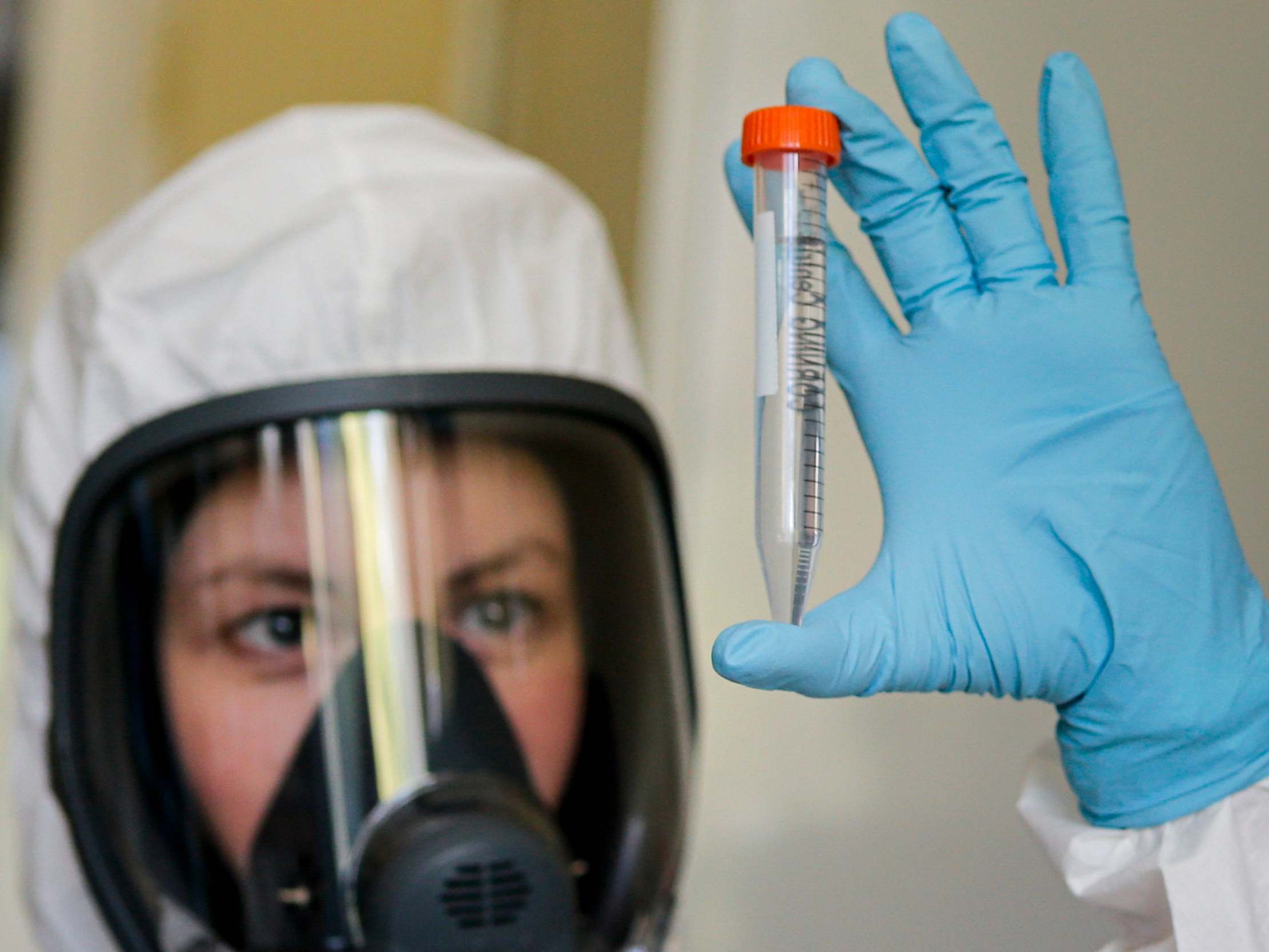 An employee shows new Russian vaccine at the Gamaleya institute in Moscow