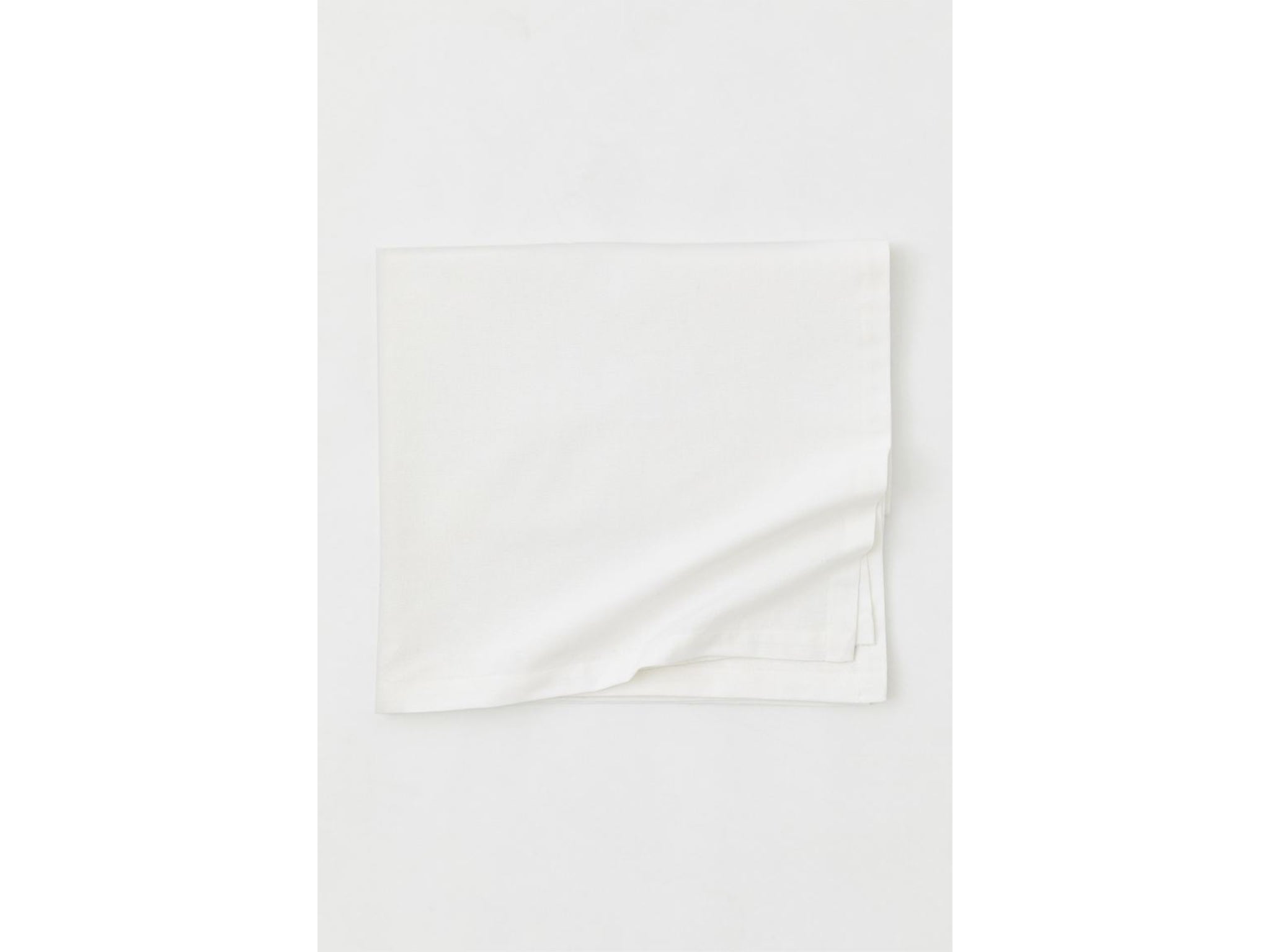 Start your table design with a simple, white tablecloth (H&amp;M)