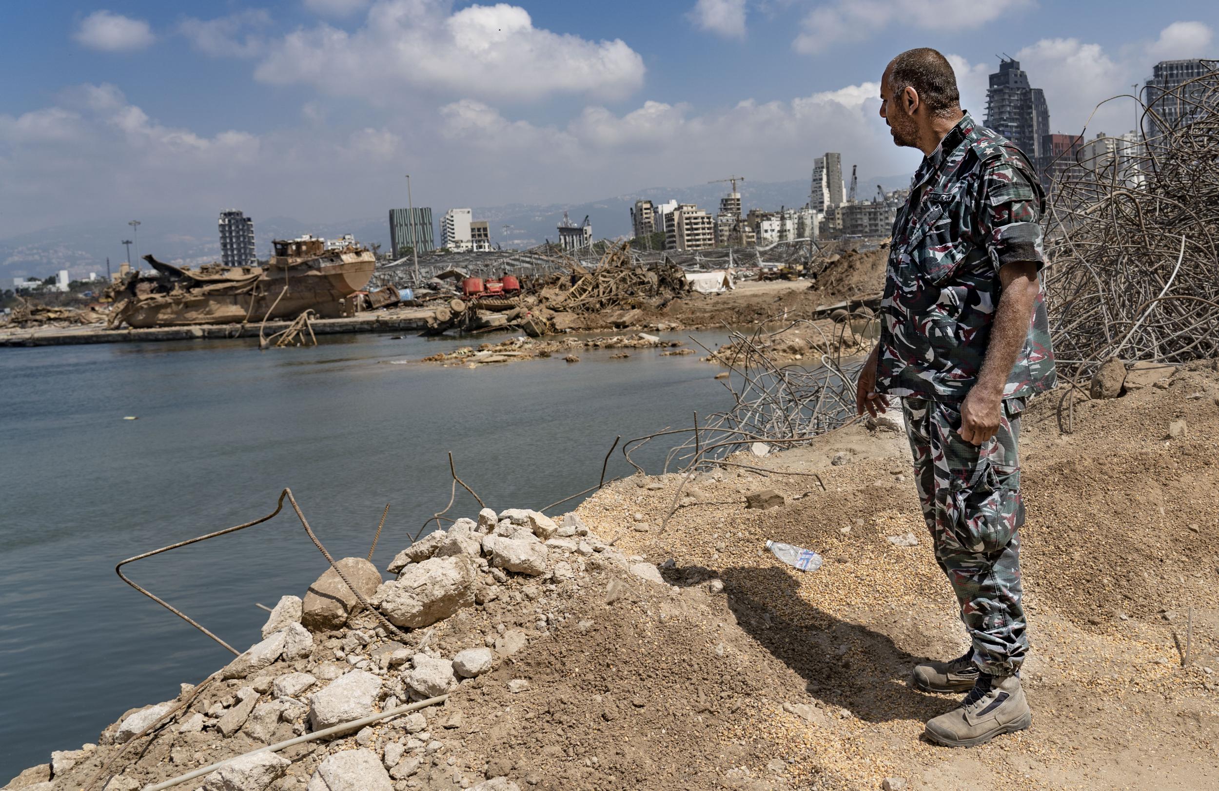 Lt. Michel el- Mur stands next to the massive crater created by last Tuesday's explosion