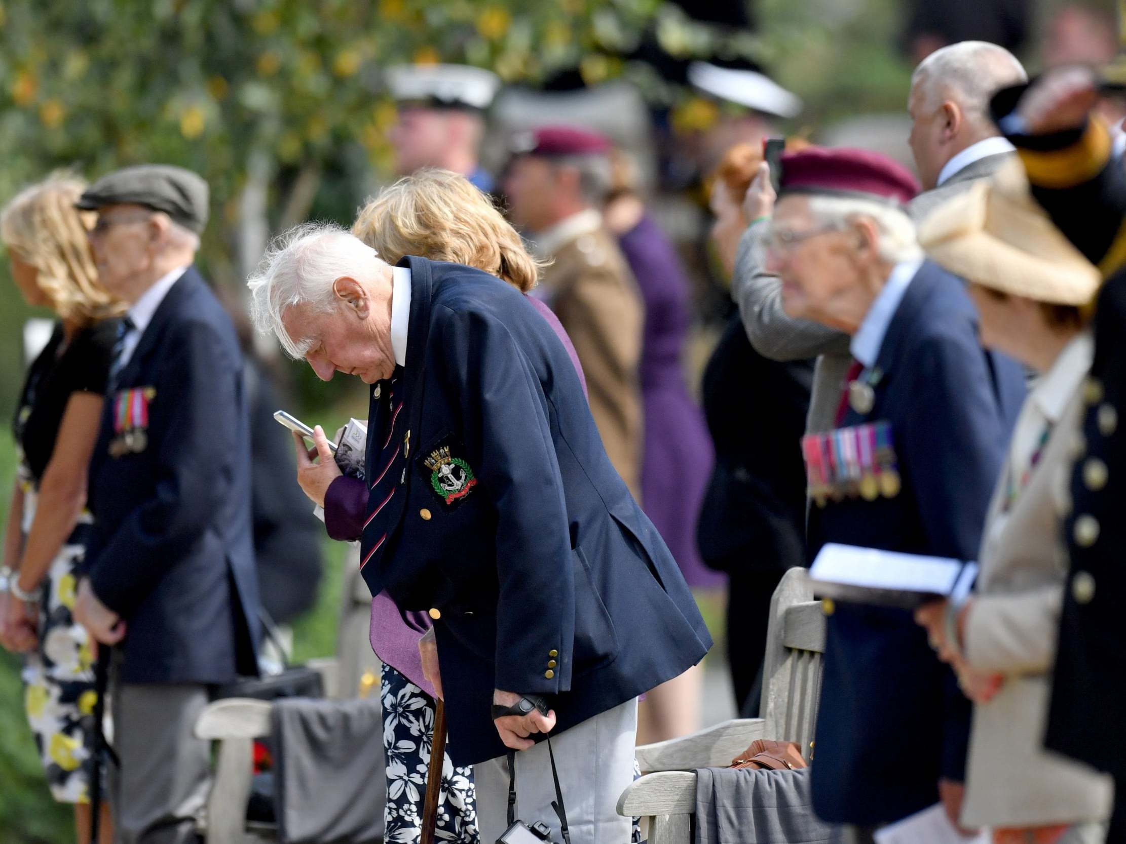 Veterans observe a moment of silence at the National Memorial Arboretum yesterday