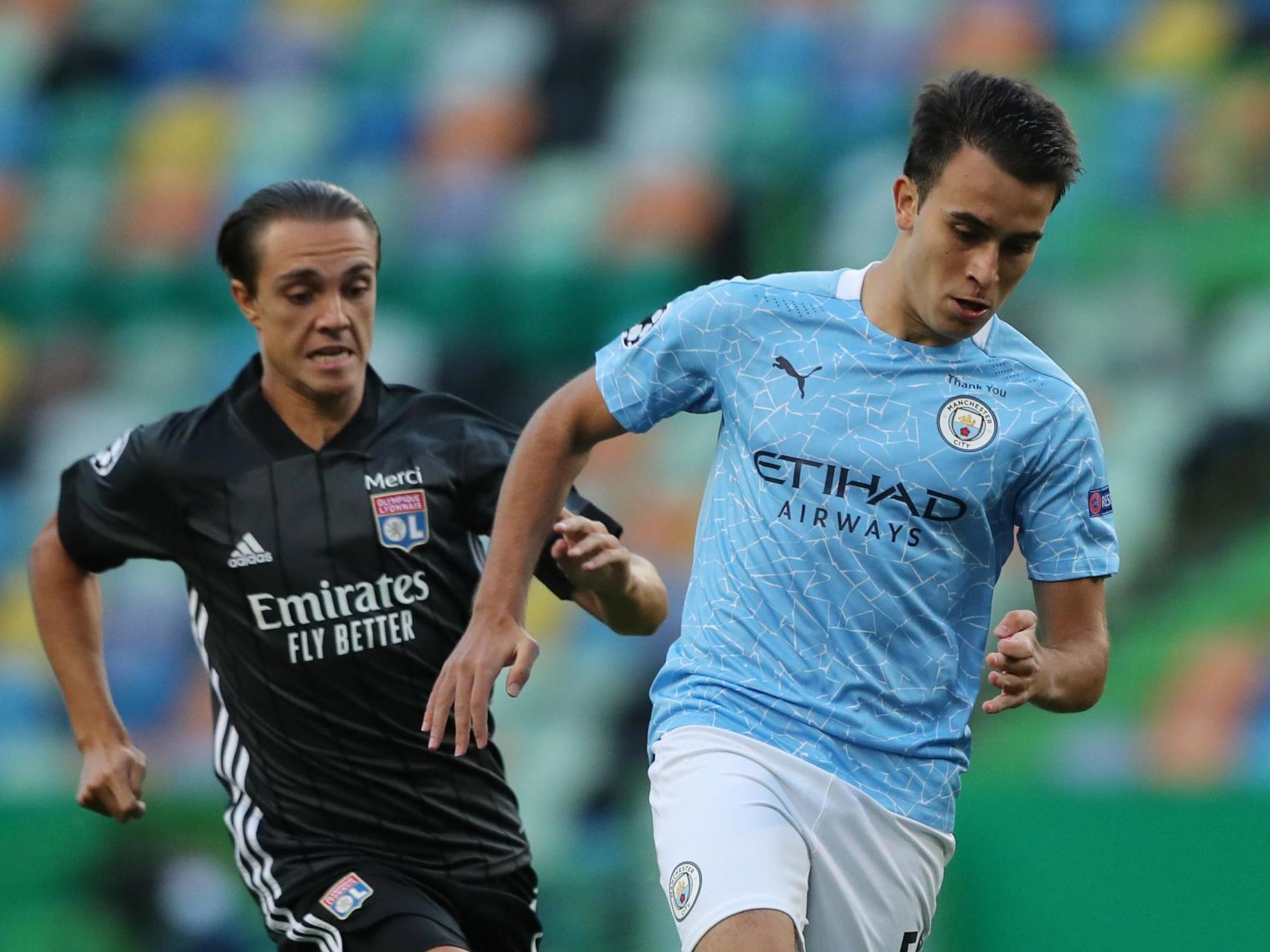 Lyon’s French midfielder Maxence Caqueret (L) vies with Manchester City’s Spanish defender Eric Garcia (POOL/AFP via Getty)