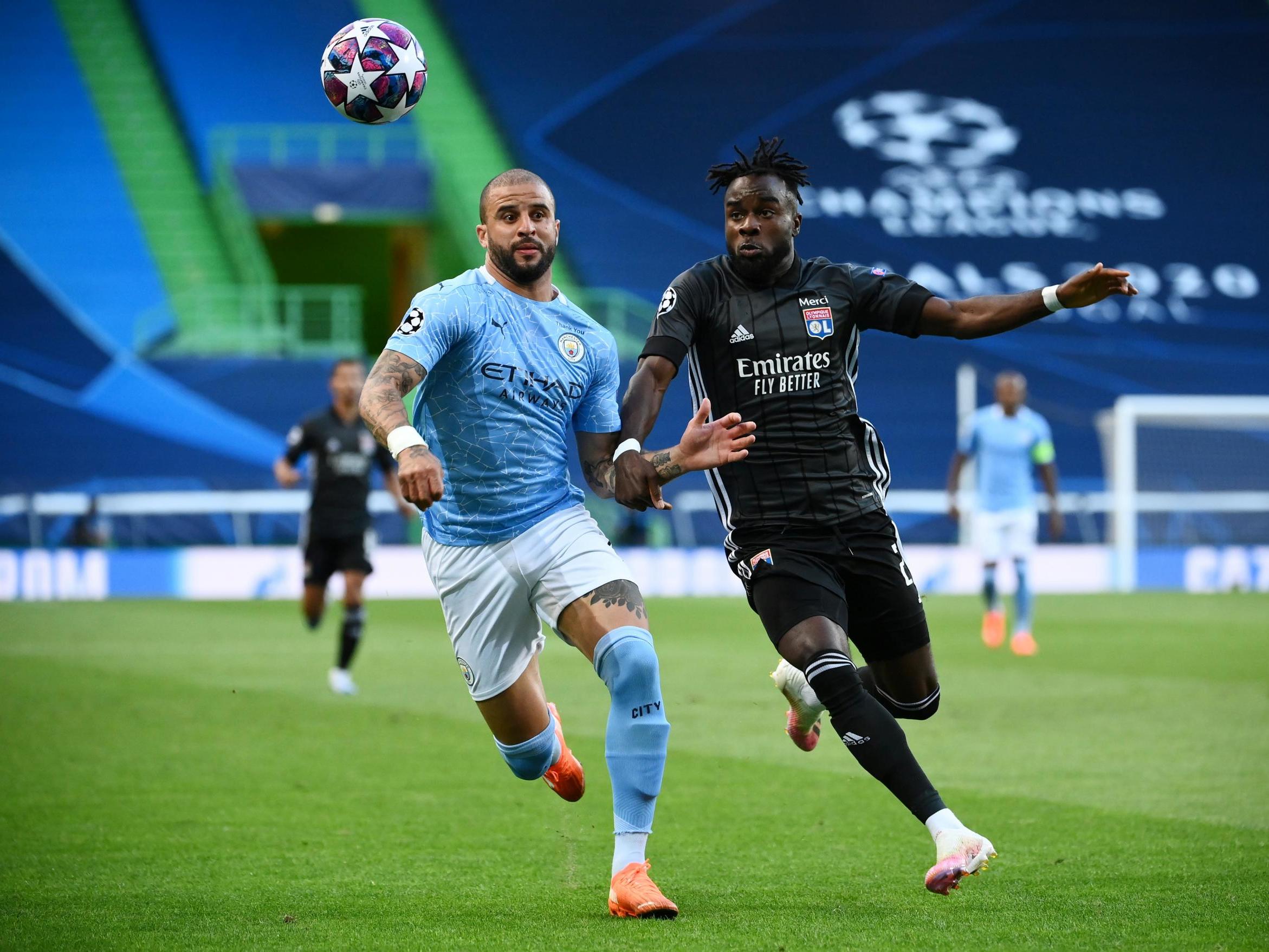 Olympique Lyonnais‘ Maxwel Cornet in action with Manchester City’s Kyle Walker